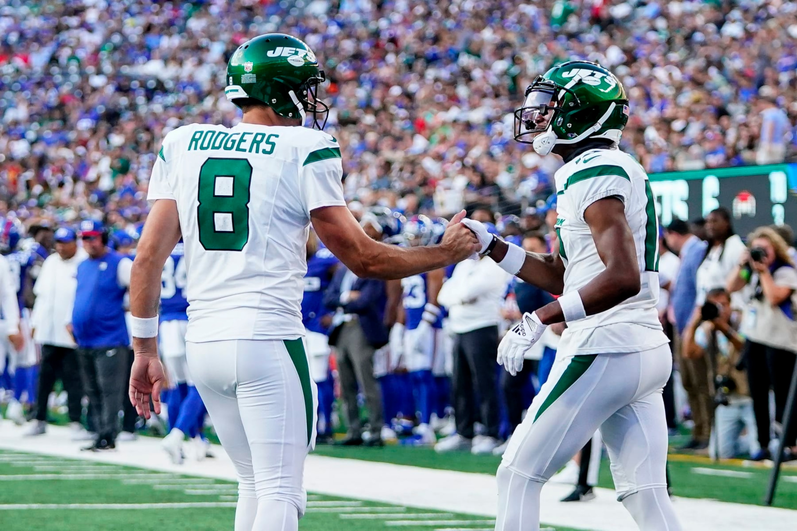 New York Jets quarterback Aaron Rodgers (8) congratulates wide receiver Garrett Wilson (17) after Wilson caught a touchdown pass during the first half of an NFL preseason football game against the New York Giants, Saturday, Aug. 26, 2023, in East Rutherford, N.J. (AP Photo/Frank Franklin II) New York Jets quarterback Aaron Rodgers (8) congratulates wide receiver Garrett Wilson (17) after Wilson caught a touchdown pass during the first half of an NFL preseason football game against the New York Giants, Saturday, Aug. 26, 2023, in East Rutherford, N.J. (AP Photo/Frank Franklin II)