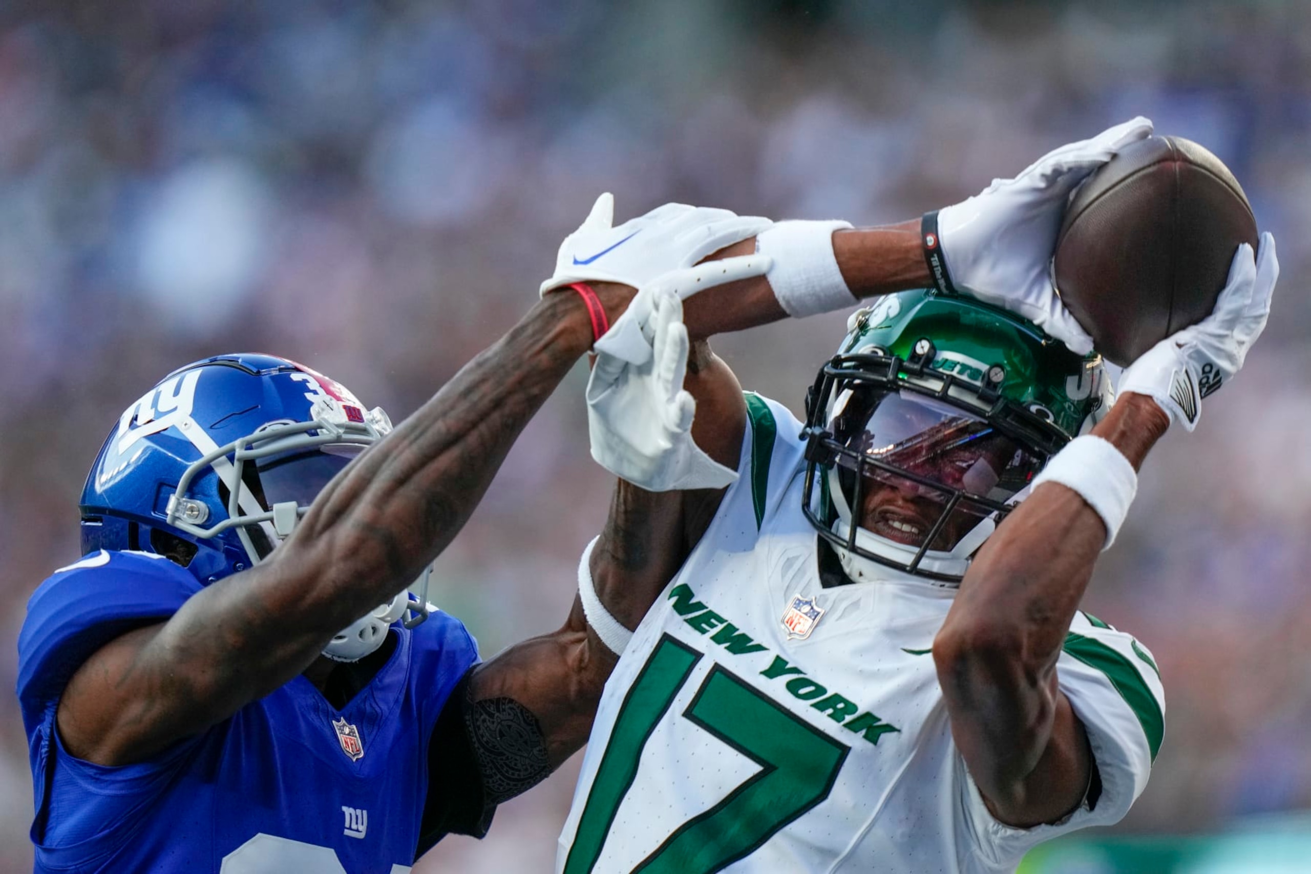 New York Jets wide receiver Garrett Wilson (17) catches a touchdown pass against New York Giants cornerback Gemon Green (34) during the first half of an NFL preseason football game, Saturday, Aug. 26, 2023, in East Rutherford, N.J. (AP Photo/Frank Franklin II) New York Jets wide receiver Garrett Wilson (17) catches a touchdown pass against New York Giants cornerback Gemon Green (34) during the first half of an NFL preseason football game, Saturday, Aug. 26, 2023, in East Rutherford, N.J. (AP Photo/Frank Franklin II)