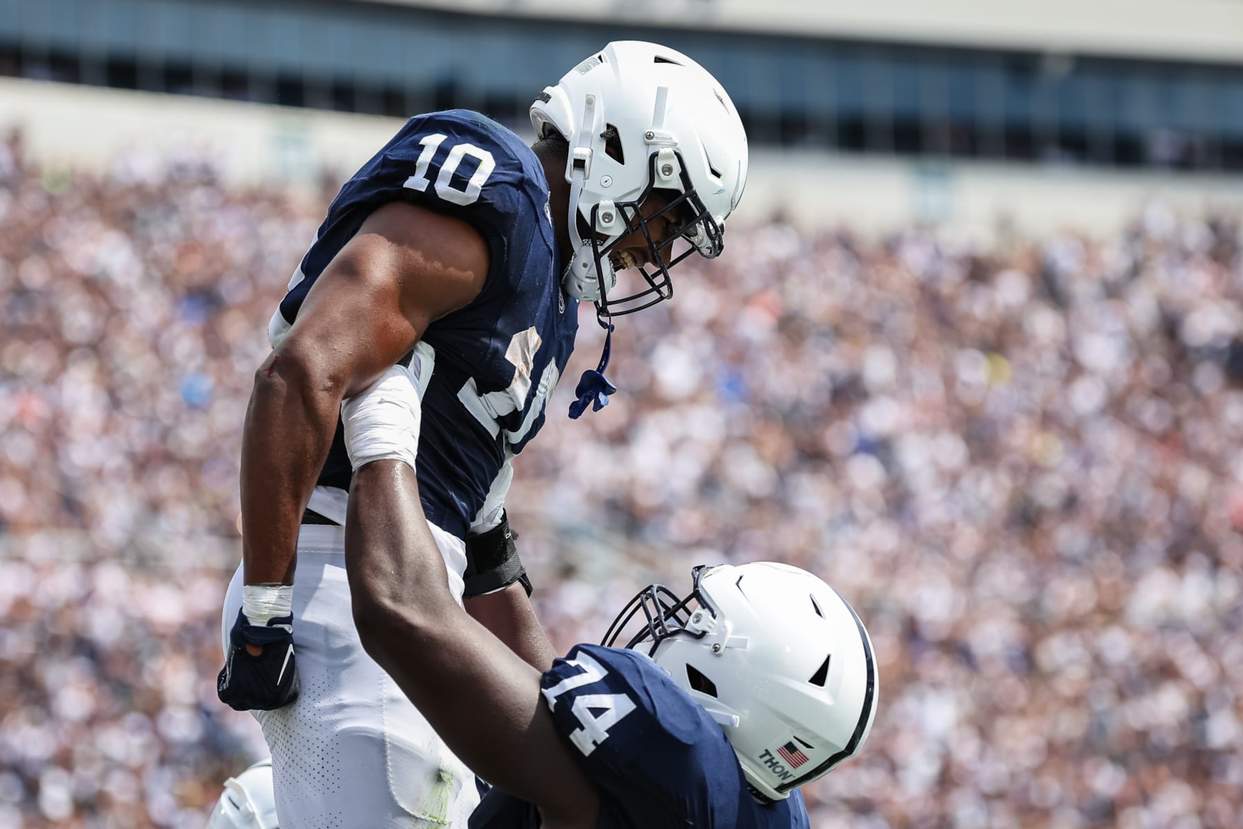 STATE COLLEGE, PA - SEPTEMBER 09: Nicholas Singleton #10 of the Penn State Nittany Lions celebrates with Olumuyiwa Fashanu #74 after scoring a touchdown against the Delaware Fightin Blue Hens during the first half at Beaver Stadium on September 9, 2023 in State College, Pennsylvania. (Photo by Scott Taetsch/Getty Images)