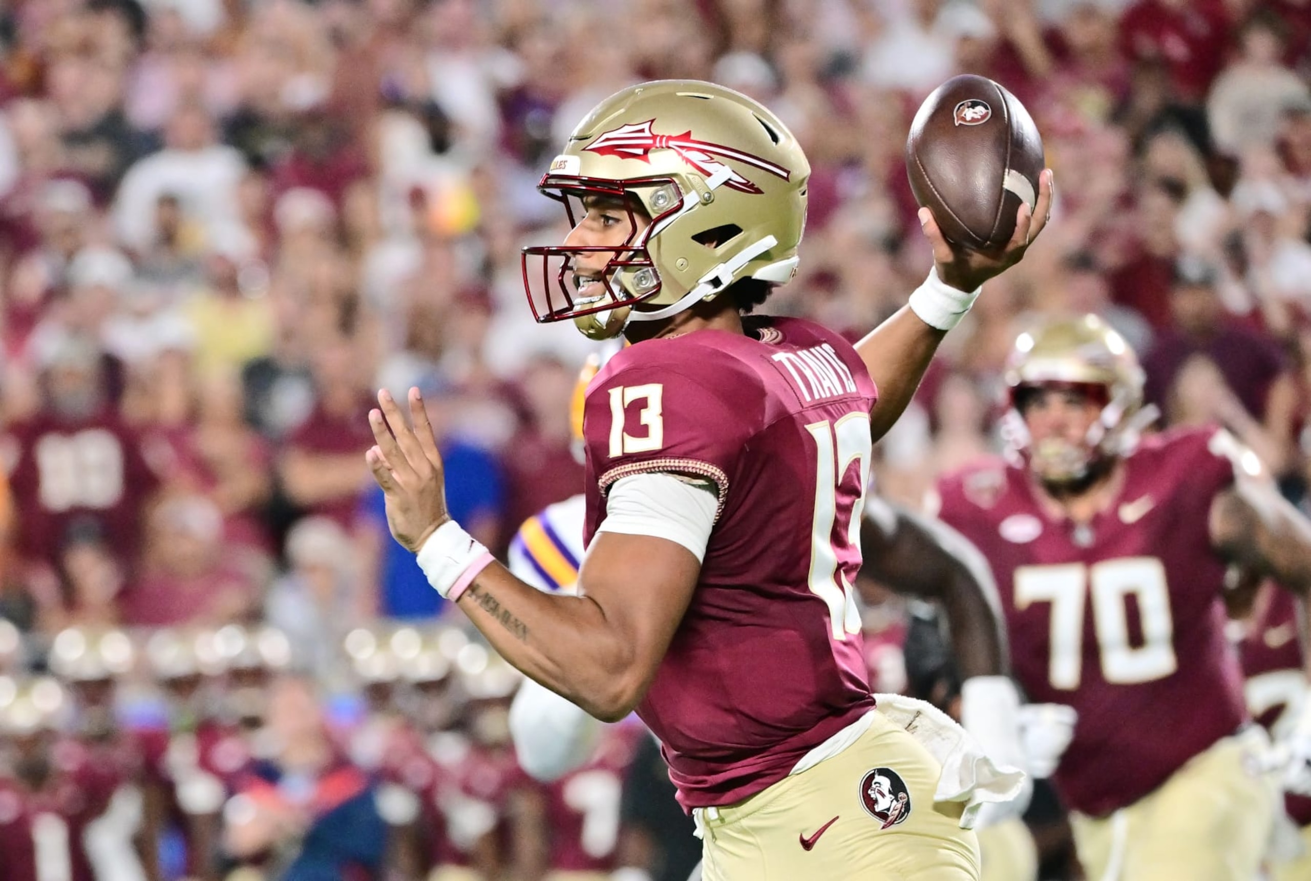 ORLANDO, FLORIDA - SEPTEMBER 03: Jordan Travis #13 of the Florida State Seminoles looks to throw a pass in the first quarter against the LSU Tigers at Camping World Stadium on September 03, 2023 in Orlando, Florida. (Photo by Julio Aguilar/Getty Images)
