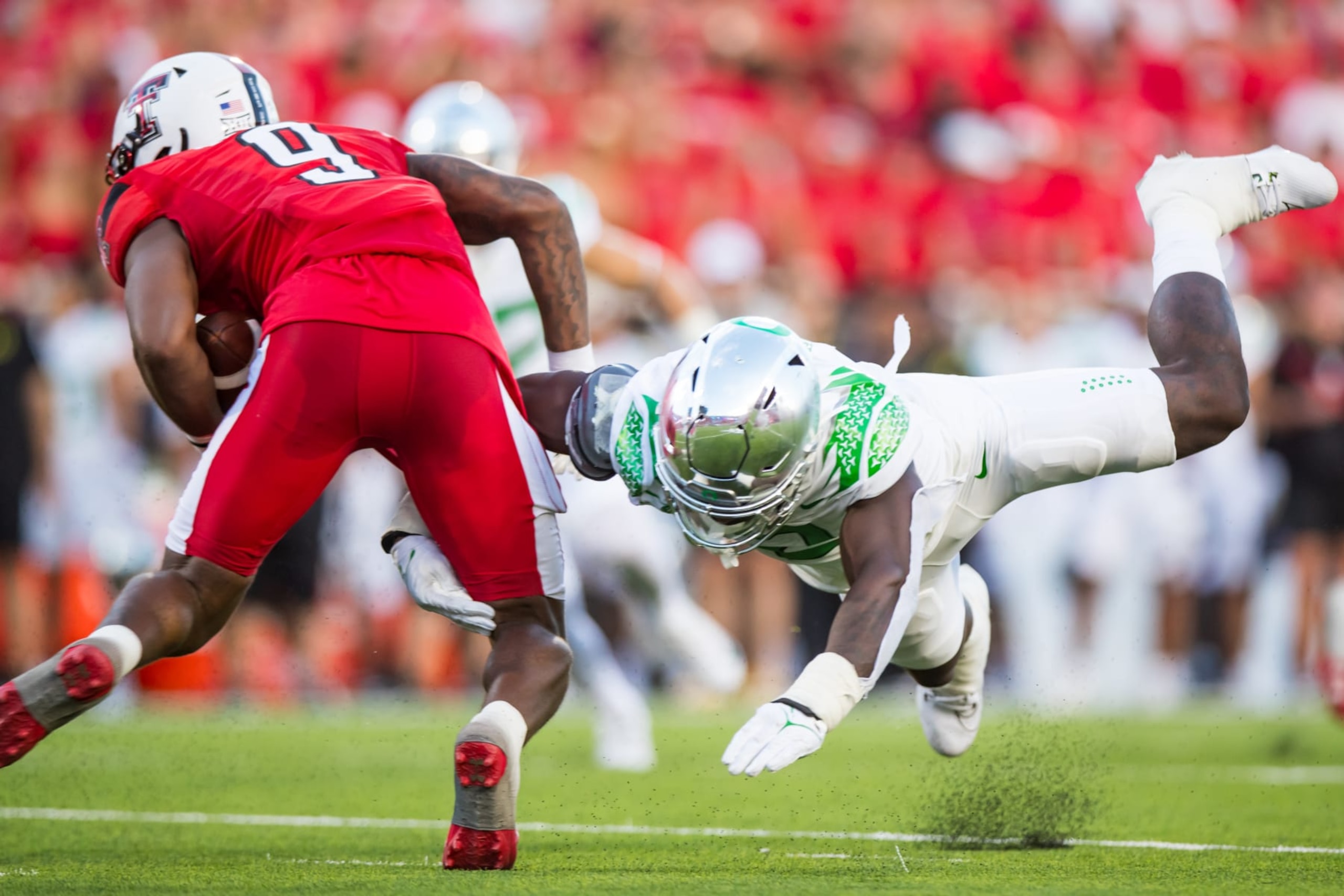 LUBBOCK, TEXAS - SEPTEMBER 09: Jeffrey Bassa #2 of the Oregon Ducks tackles Jarand Bradley #9 of the Texas Tech Red Raiders during the first half of the game at Jones AT&T Stadium on September 09, 2023 in Lubbock, Texas. (Photo by John E. Moore III/Getty Images) LUBBOCK, TEXAS - SEPTEMBER 09: Jeffrey Bassa #2 of the Oregon Ducks tackles Jarand Bradley #9 of the Texas Tech Red Raiders during the first half of the game at Jones AT&T Stadium on September 09, 2023 in Lubbock, Texas. (Photo by John E. Moore III/Getty Images)