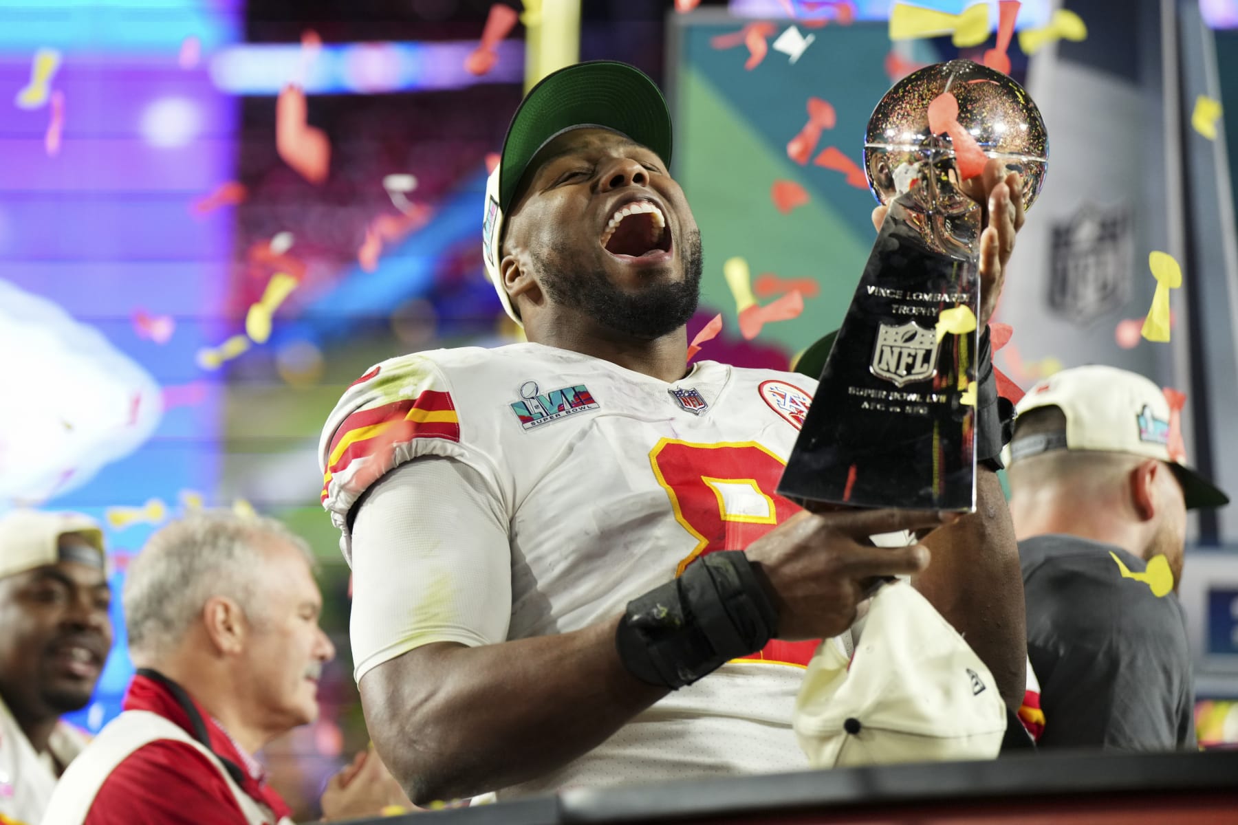 GLENDALE, AZ - FEBRUARY 12: Carlos Dunlap #8 of the Kansas City Chiefs hoists the Lombardi Trophy after Super Bowl LVII against the Philadelphia Eagles at State Farm Stadium on February 12, 2023 in Glendale, Arizona. The Chiefs defeated the Eagles 38-35. (Photo by Cooper Neill/Getty Images)