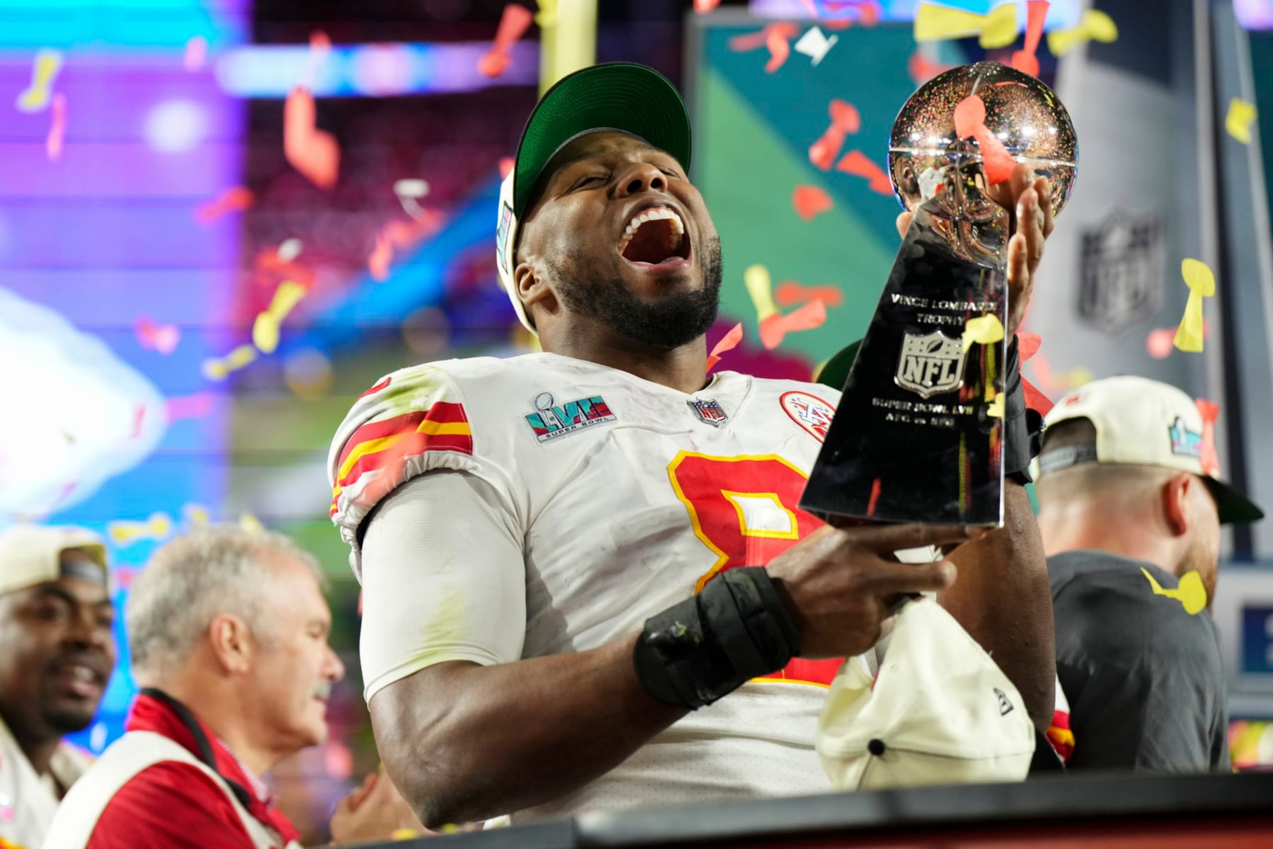 GLENDALE, AZ - FEBRUARY 12: Carlos Dunlap #8 of the Kansas City Chiefs hoists the Lombardi Trophy after Super Bowl LVII against the Philadelphia Eagles at State Farm Stadium on February 12, 2023 in Glendale, Arizona. The Chiefs defeated the Eagles 38-35. (Photo by Cooper Neill/Getty Images)