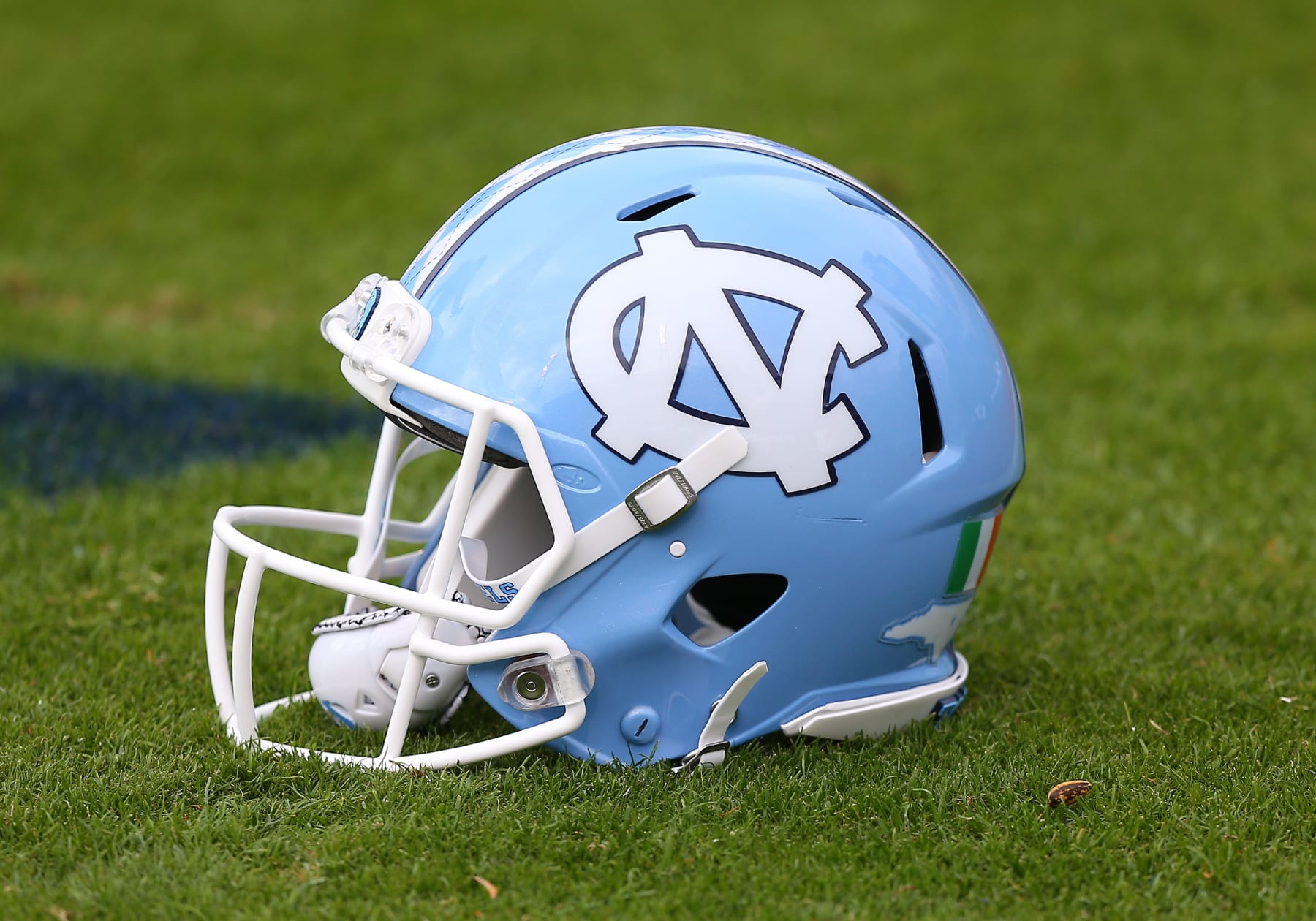 CHARLOTTESVILLE, VA - NOVEMBER 05: North Carolina Tar Heels helmet resting on the field during pregame drills prior to a college football game between the North Carolina Tar Heels and the Virginia Cavaliers on November 05, 2022, at Scott Stadium in Charlottesville, VA. (Photo by Lee Coleman/Icon Sportswire via Getty Images)
