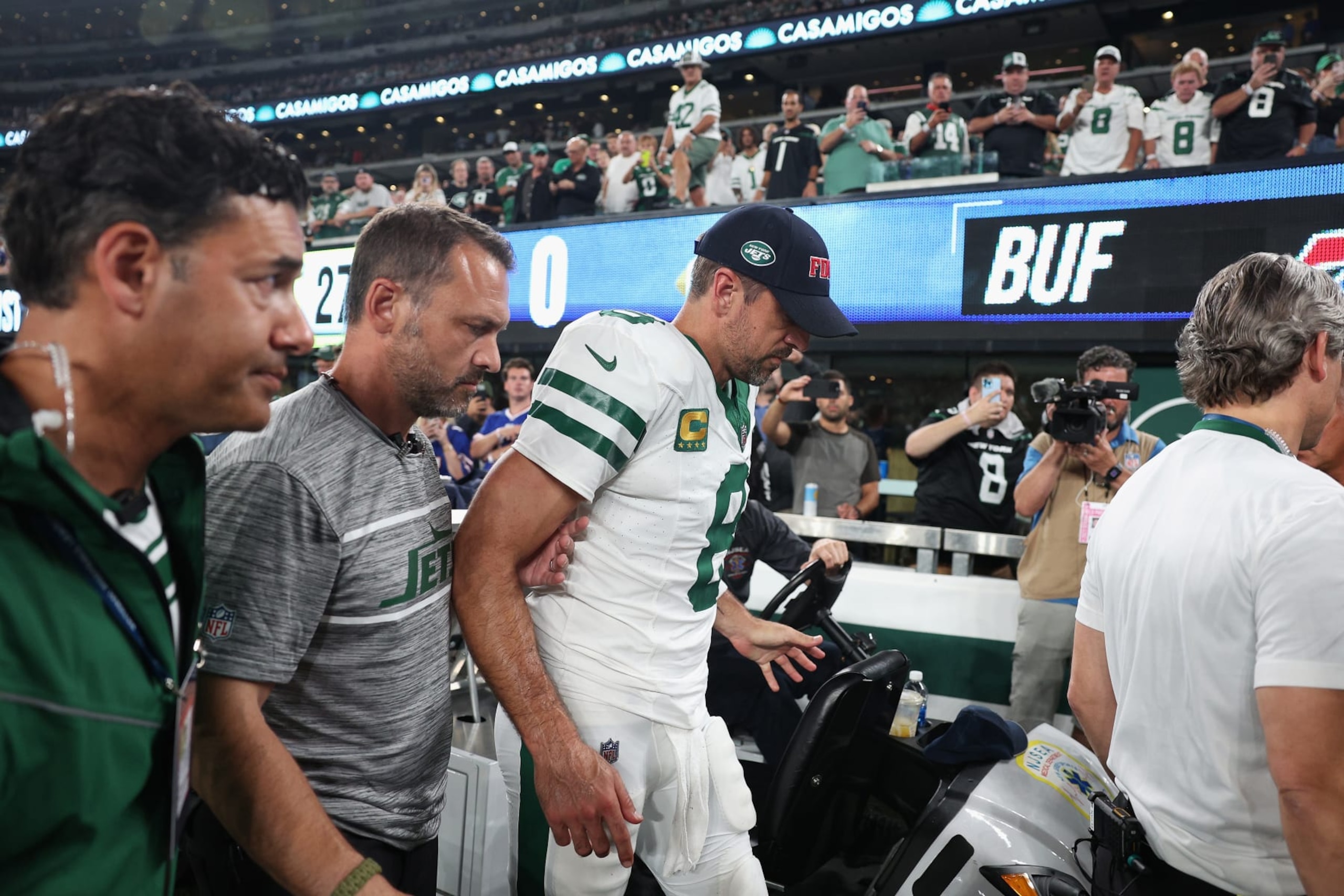 EAST RUTHERFORD, NEW JERSEY - SEPTEMBER 11: Quarterback Aaron Rodgers #8 of the New York Jets is helped off the field after an injury during the first quarter of the NFL game against the Buffalo Bills at MetLife Stadium on September 11, 2023 in East Rutherford, New Jersey. (Photo by Elsa/Getty Images)
