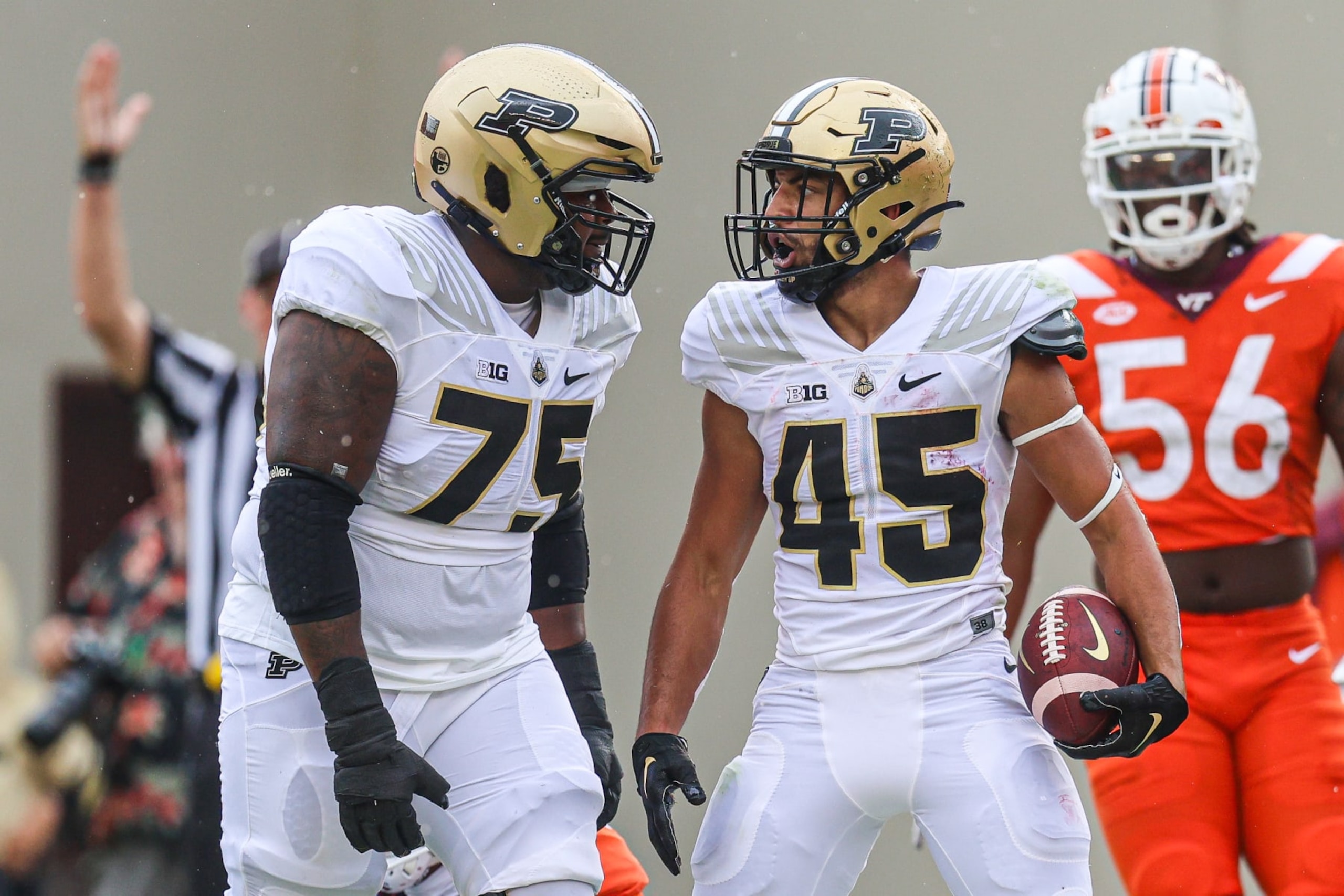BLACKSBURG, VIRGINIA - SEPTEMBER 9: Jalen Grant #75 and Devin Mockobee #45 of the Purdue Boilermakers celebrate after a touchdown against the Virginia Tech Hokies in the first half during a game at Lane Stadium on September 9, 2023 in Blacksburg, Virginia. (Photo by Ryan Hunt/Getty Images)