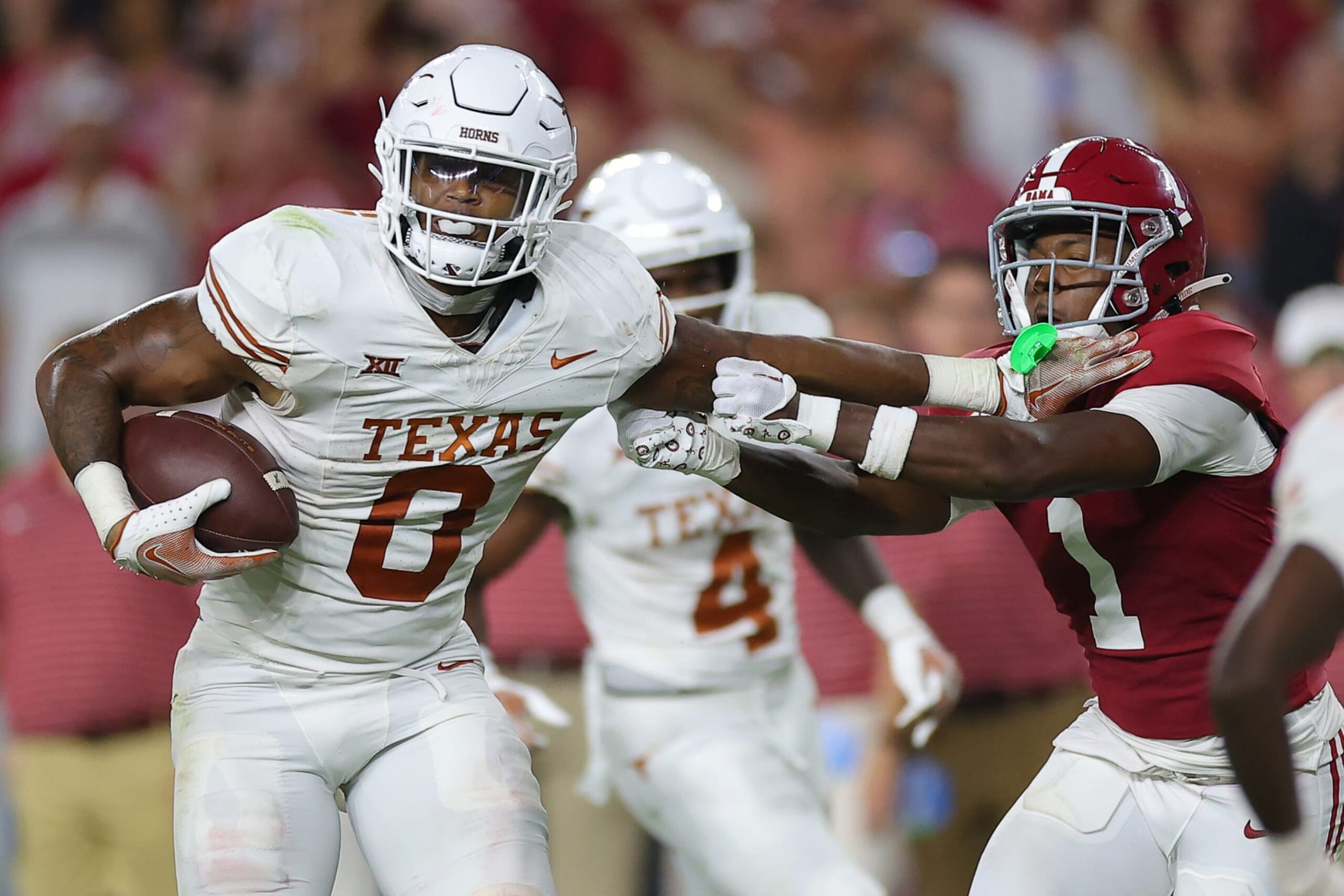TUSCALOOSA, ALABAMA - SEPTEMBER 09: Anthony Hill Jr. #0 of the Texas Longhorns avoids a tackle by Kool-Aid McKinstry #1 of the Alabama Crimson Tide during the fourth quarter at Bryant-Denny Stadium on September 09, 2023 in Tuscaloosa, Alabama. (Photo by Kevin C. Cox/Getty Images)