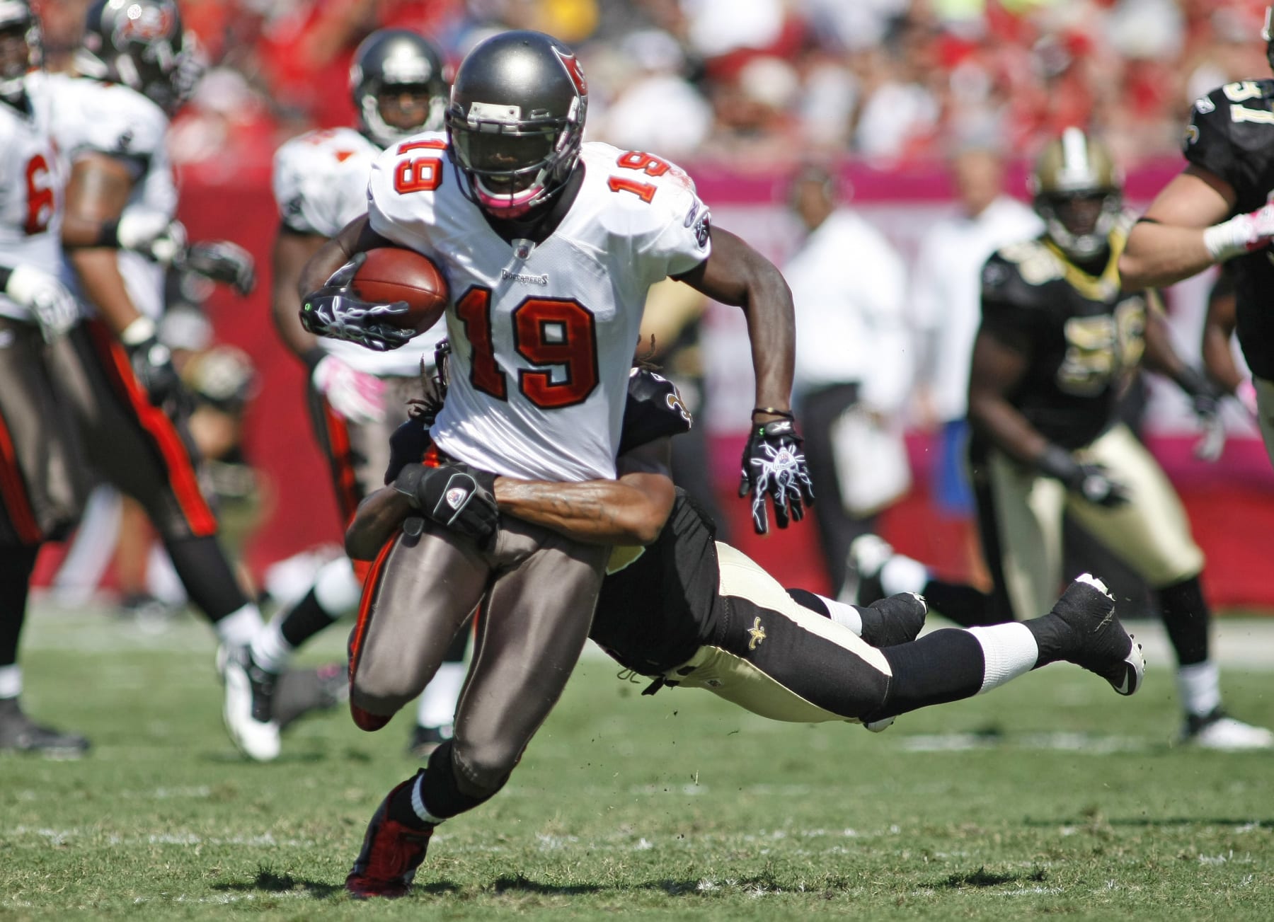 Tampa Bay Buccaneers receiver Mike Williams (19) is taken down by New Orleans Saints defender Patrick Robinson (34) in the first half of their NFL football game in Tampa, Fla., Sunday, Oct. 17, 2010. (AP Photo/Brian Blanco)