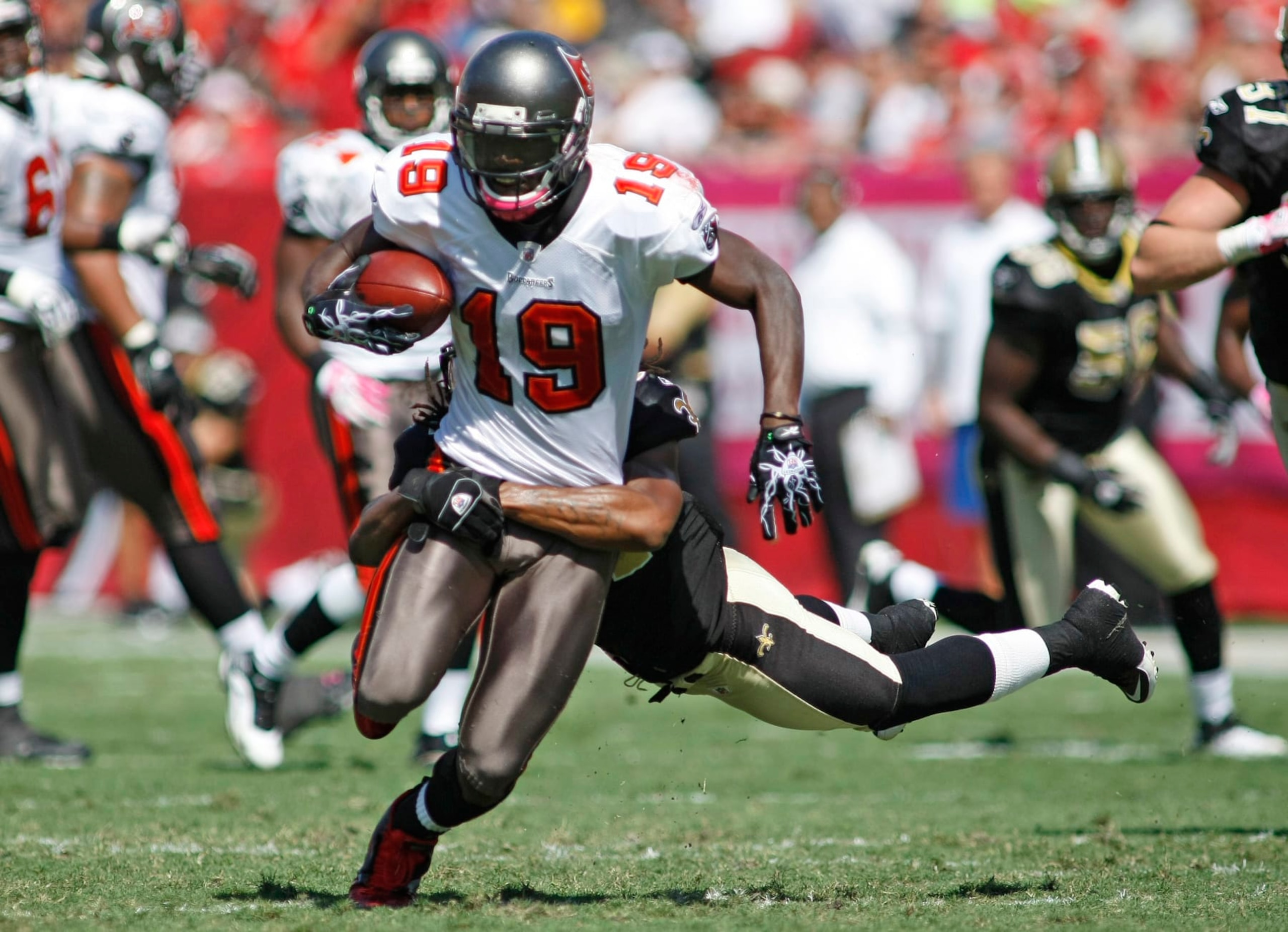 Tampa Bay Buccaneers receiver Mike Williams (19) is taken down by New Orleans Saints defender Patrick Robinson (34) in the first half of their NFL football game in Tampa, Fla., Sunday, Oct. 17, 2010. (AP Photo/Brian Blanco)