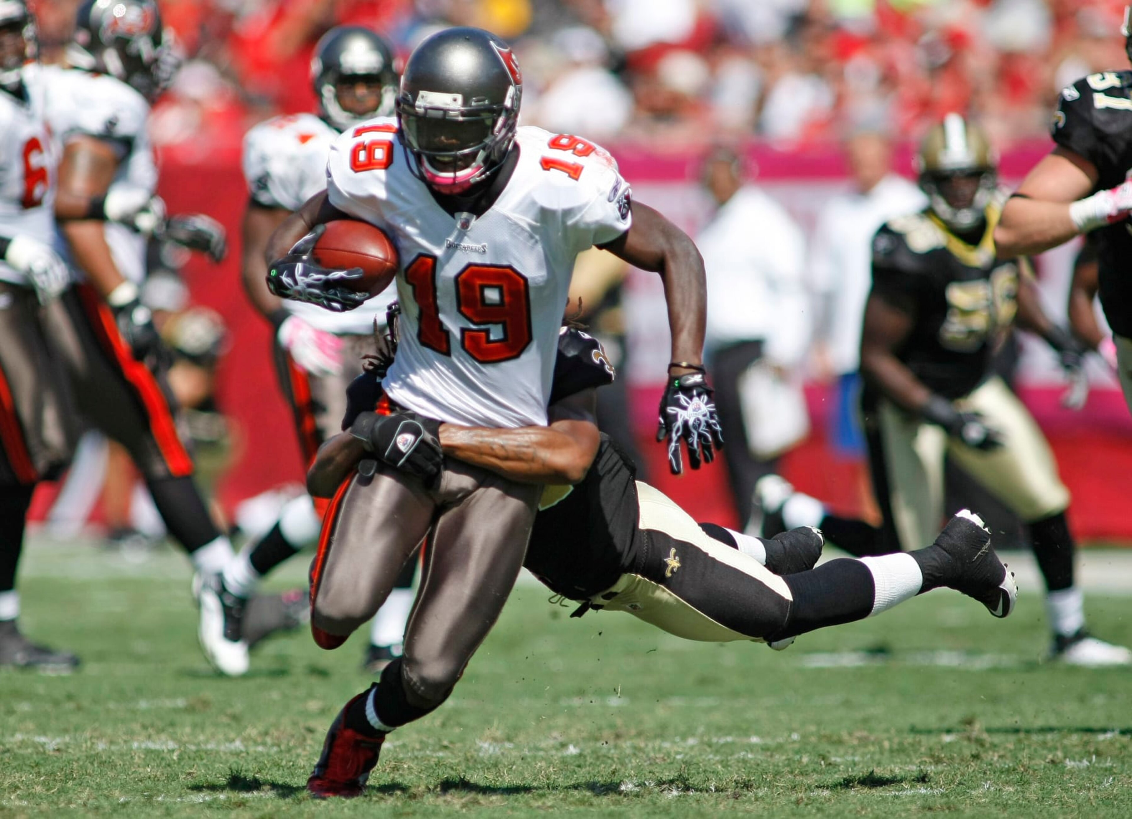 Tampa Bay Buccaneers receiver Mike Williams (19) is taken down by New Orleans Saints defender Patrick Robinson (34) in the first half of their NFL football game in Tampa, Fla., Sunday, Oct. 17, 2010. (AP Photo/Brian Blanco)