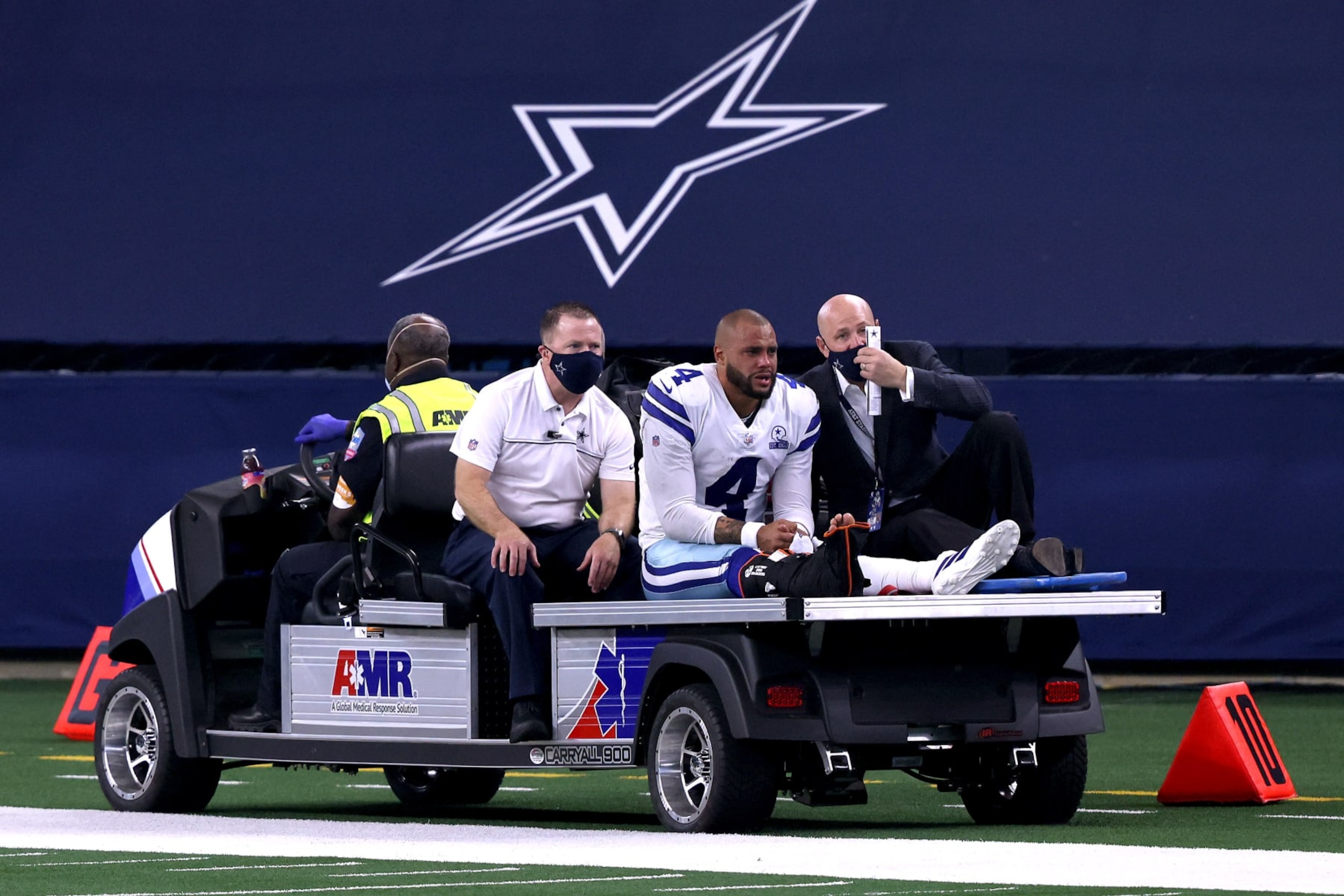 ARLINGTON, TEXAS - OCTOBER 11:  Dak Prescott #4 of the Dallas Cowboys is carted off the field after sustaining a leg injury against the New York Giants during the third quarter at AT&T Stadium on October 11, 2020 in Arlington, Texas. (Photo by Tom Pennington/Getty Images)