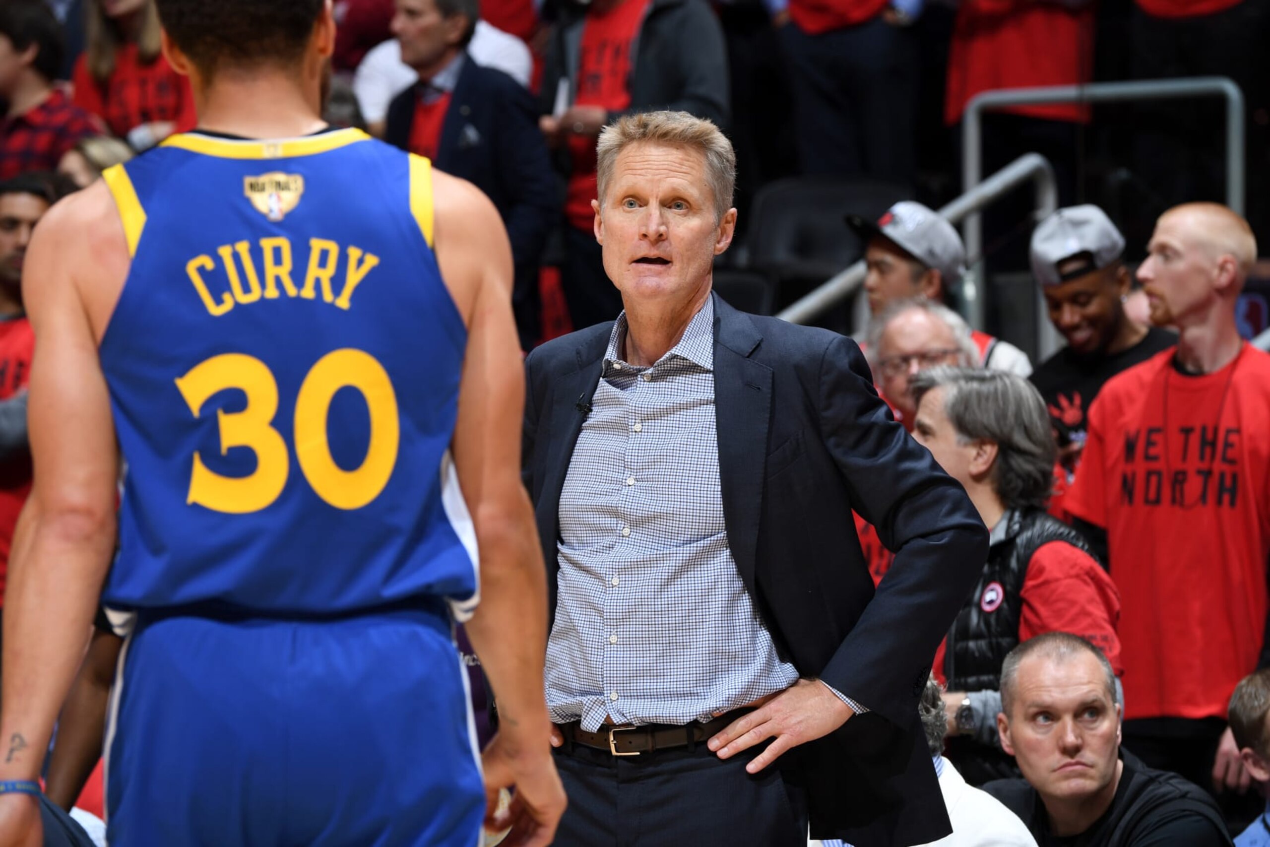 TORONTO, CANADA - JUNE 10: Stephen Curry #30 and Head Coach Steve Kerr of the Golden State Warriors talk during Game Five of the NBA Finals against the Toronto Raptors on June 10, 2019 at Scotiabank Arena in Toronto, Ontario, Canada. NOTE TO USER: User expressly acknowledges and agrees that, by downloading and/or using this photograph, user is consenting to the terms and conditions of the Getty Images License Agreement. Mandatory Copyright Notice: Copyright 2019 NBAE (Photo by Andrew D. Bernstein/NBAE via Getty Images)