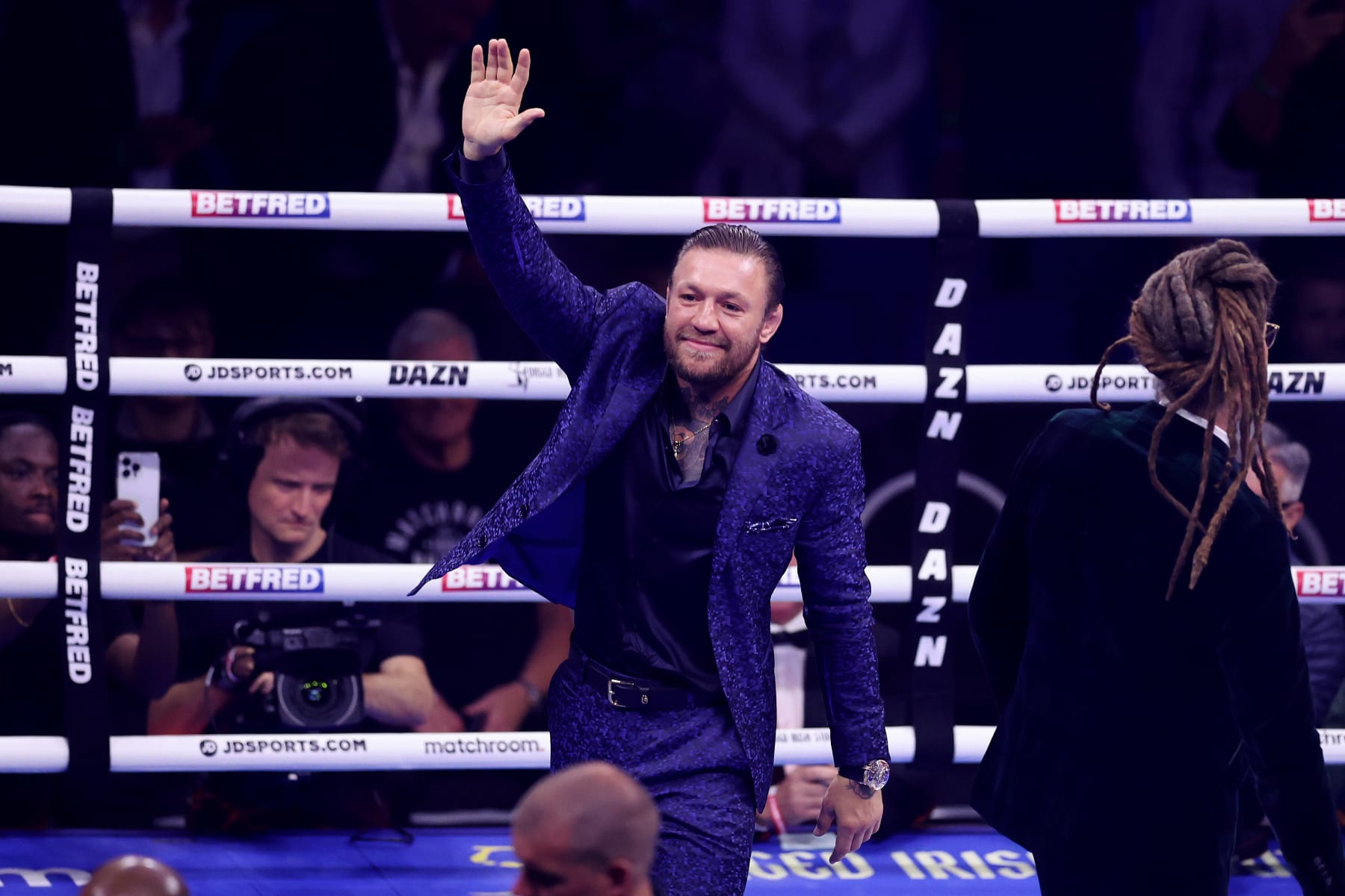 LONDON, ENGLAND - AUGUST 12: Mixed Martial Artist Conor McGregor acknowledges the fans prior to the Heavyweight fight between Derek Chisora and Gerald Washington at The O2 Arena on August 12, 2023 in London, England. (Photo by Julian Finney/Getty Images)