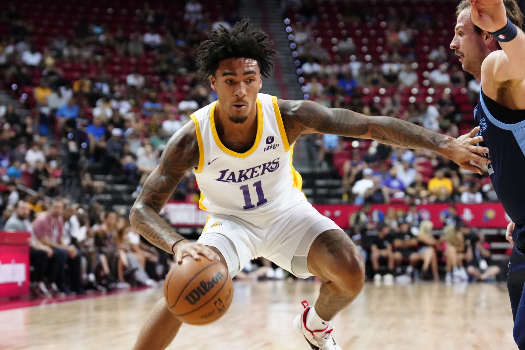 LAS VEGAS, NEVADA - JULY 14: Jalen Hood-Schifino #11 of the Los Angeles Lakers drives against Frankie Ferrari #2 of the Memphis Grizzlies in the second half of a 2023 NBA Summer League game at the Thomas & Mack Center on July 14, 2023 in Las Vegas, Nevada. NOTE TO USER: User expressly acknowledges and agrees that, by downloading and or using this photograph, User is consenting to the terms and conditions of the Getty Images License Agreement. (Photo by Louis Grasse/Getty Images)