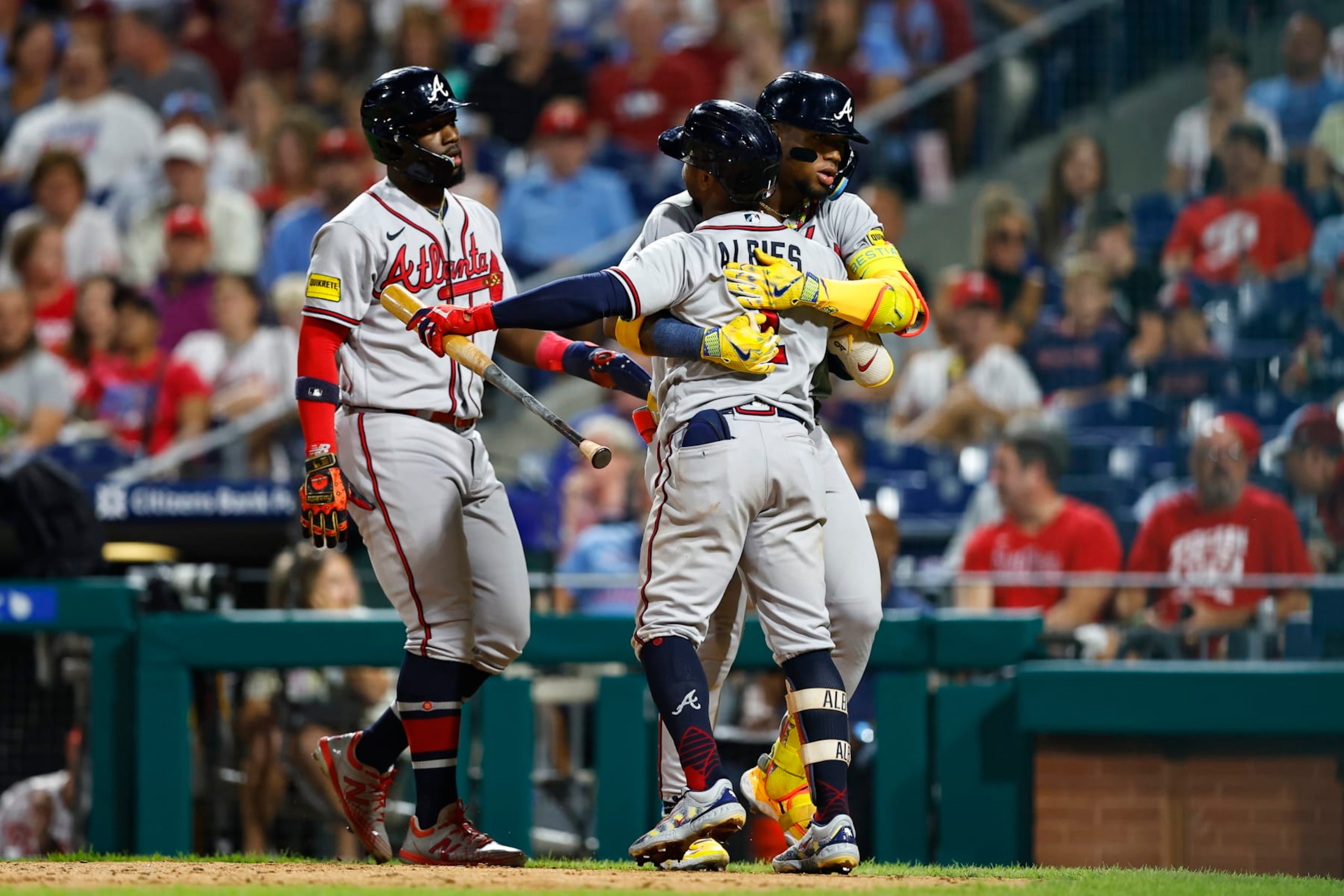 PHILADELPHIA, PA - SEPTEMBER 12:  Ronald Acuna Jr. #13 of the Atlanta Braves hugs Ozzie Albies #1  after hitting a home run during the Major League Baseball game against the Philadelphia Phillies on September 12, 2023 at Citizens Bank Park in Philadelphia, Pennsylvania.  (Photo by Rich Graessle/Icon Sportswire via Getty Images)