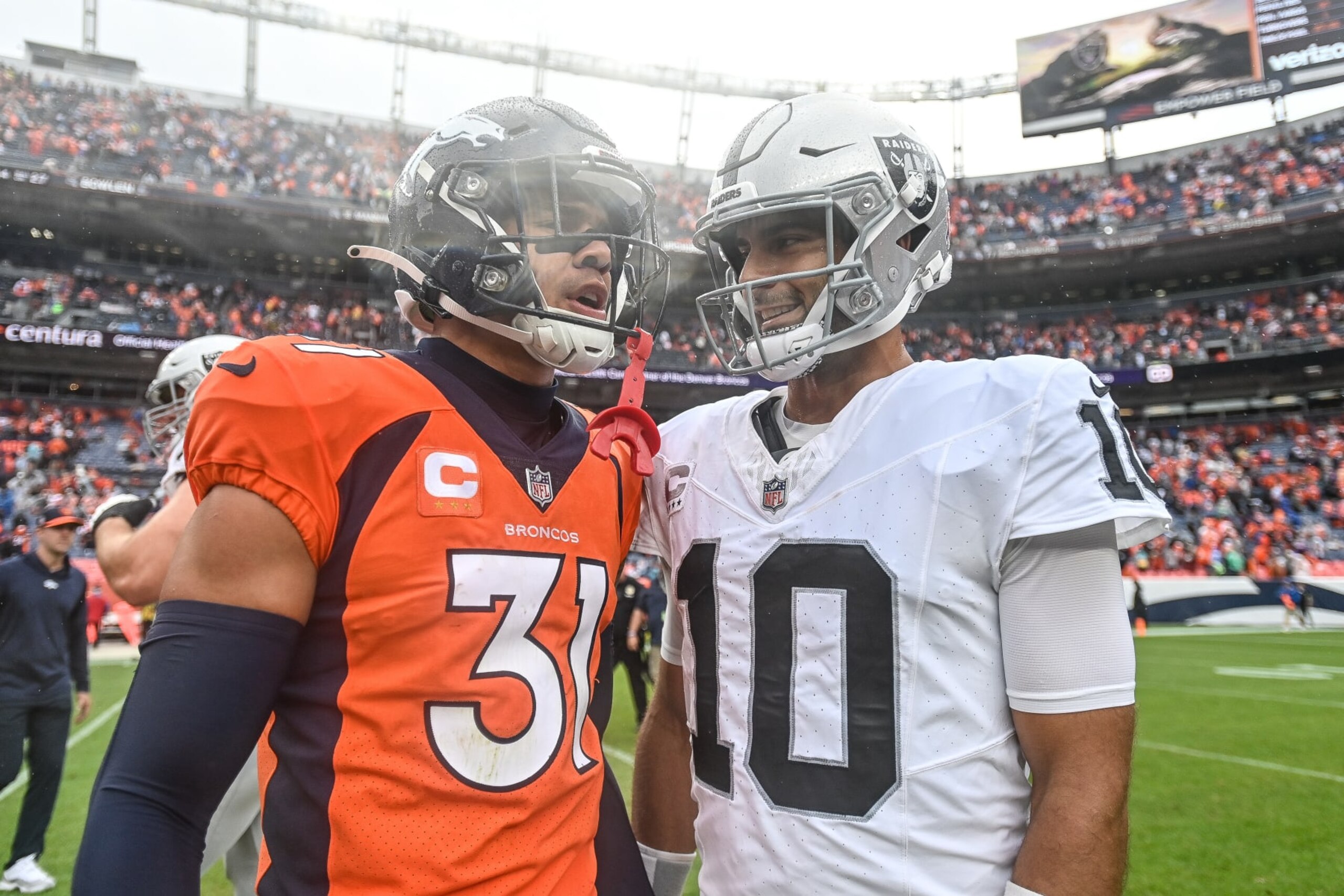 DENVER, COLORADO - SEPTEMBER 10: Jimmy Garoppolo #10 of the Las Vegas Raiders and Justin Simmons #31 of the Denver Broncos have a word after a game at Empower Field at Mile High on September 10, 2023 in Denver, Colorado. (Photo by Dustin Bradford/Getty Images) DENVER, COLORADO - SEPTEMBER 10: Jimmy Garoppolo #10 of the Las Vegas Raiders and Justin Simmons #31 of the Denver Broncos have a word after a game at Empower Field at Mile High on September 10, 2023 in Denver, Colorado. (Photo by Dustin Bradford/Getty Images)