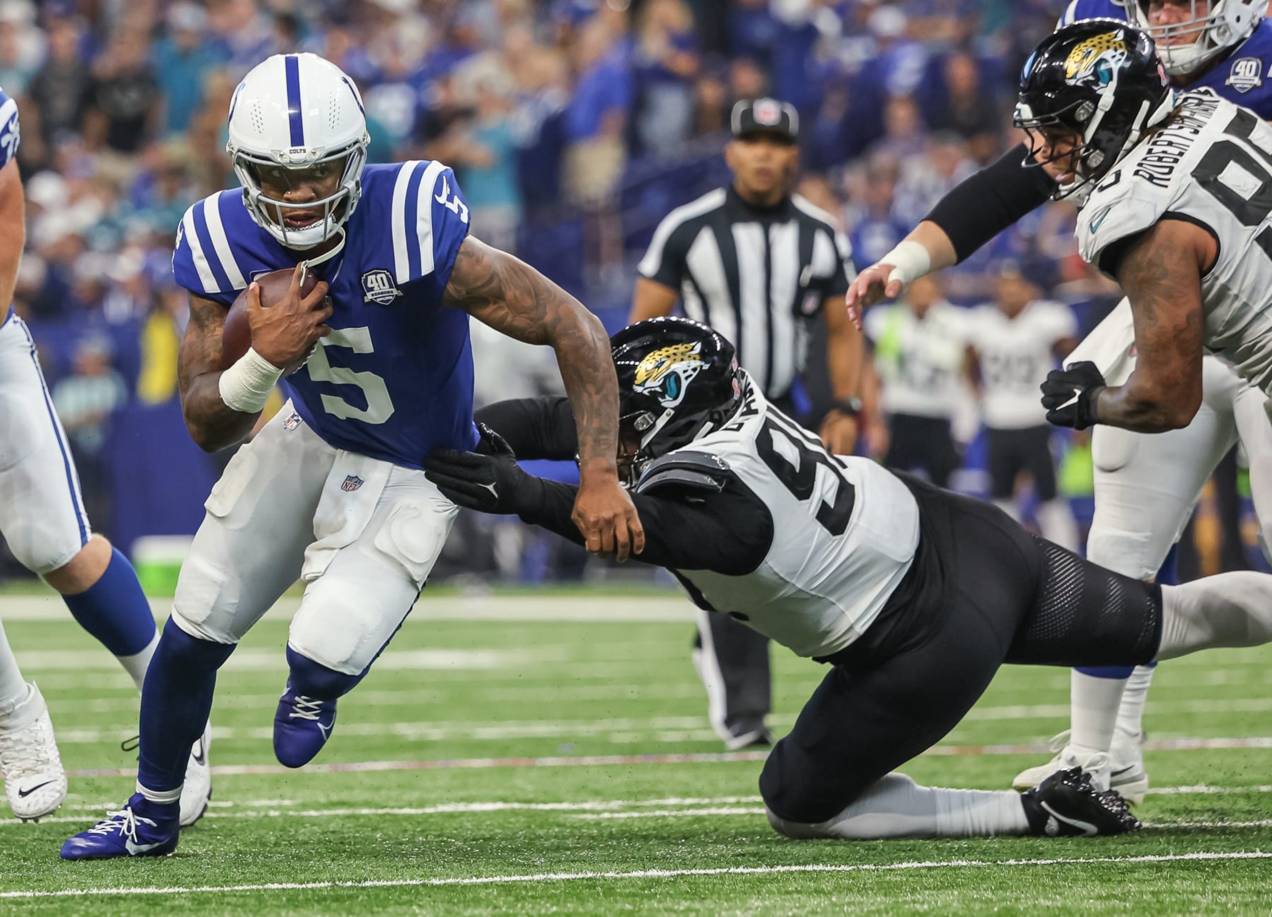 INDIANAPOLIS, INDIANA - SEPTEMBER 10: Anthony Richardson #5 of the Indianapolis Colts runs the ball as Angelo Blackson #90 of the Jacksonville Jaguars reaches for the tackle at Lucas Oil Stadium on September 10, 2023 in Indianapolis, Indiana. (Photo by Michael Hickey/Getty Images)