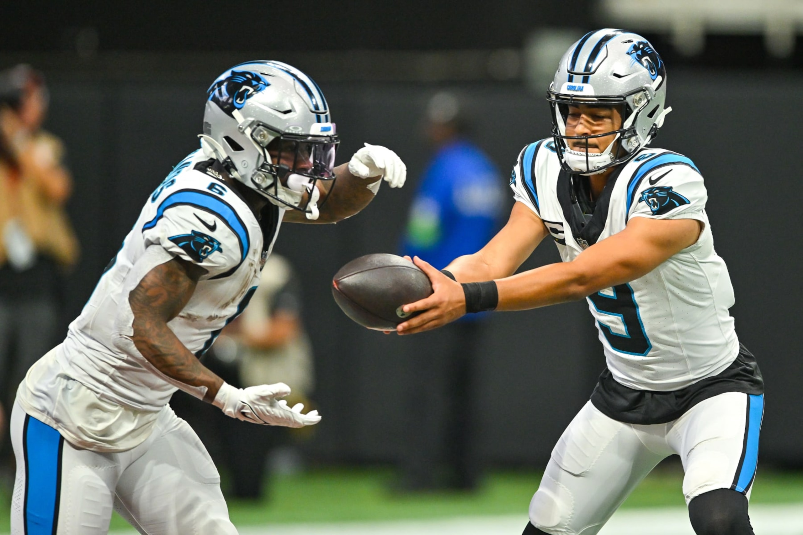 ATLANTA, GA  SEPTEMBER 10:  Carolina quarterback Bryce Young (9) hands the ball off to running back Miles Sanders (6) during the NFL game between the Carolina Panthers and the Atlanta Falcons on September 10th, 2023 at Mercedes-Benz Stadium in Atlanta, GA.  (Photo by Rich von Biberstein/Icon Sportswire via Getty Images)