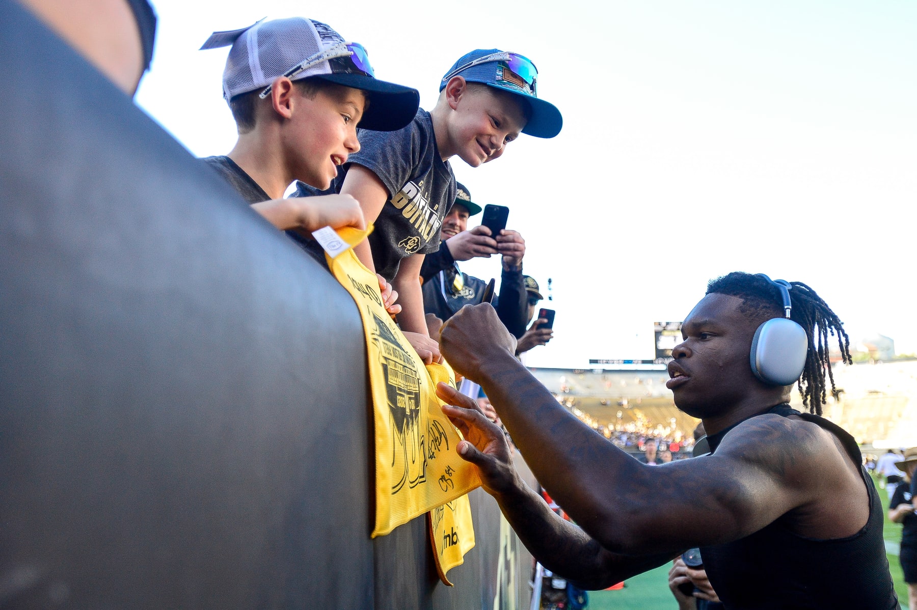 BOULDER, CO - SEPTEMBER 9:  Travis Hunter #12 of the Colorado Buffaloes greets fans as he warms up before a game against the Nebraska Cornhuskers at Folsom Field on September 9, 2023 in Boulder, Colorado. (Photo by Dustin Bradford/Getty Images)