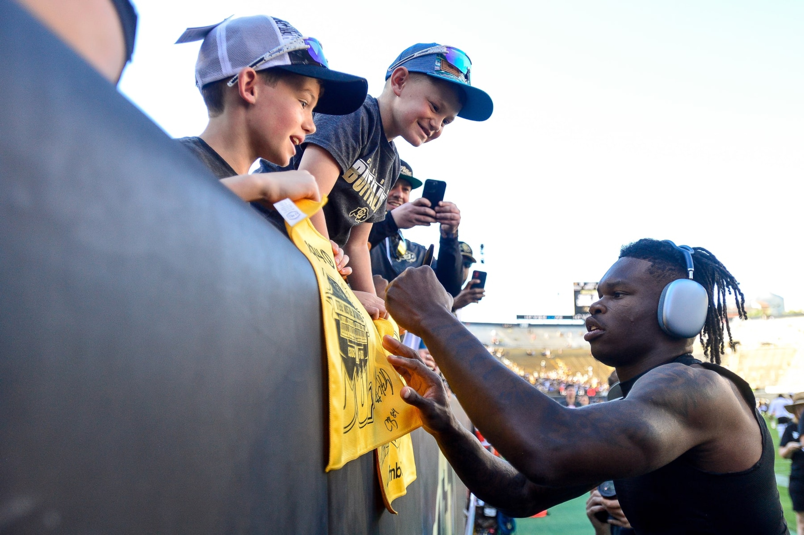 BOULDER, CO - SEPTEMBER 9:  Travis Hunter #12 of the Colorado Buffaloes greets fans as he warms up before a game against the Nebraska Cornhuskers at Folsom Field on September 9, 2023 in Boulder, Colorado. (Photo by Dustin Bradford/Getty Images)