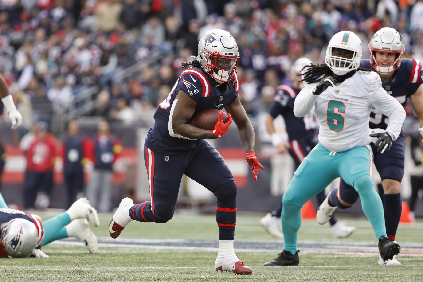 FOXBOROUGH, MASSACHUSETTS - JANUARY 01: Rhamondre Stevenson #38 of the New England Patriots runs against the Miami Dolphins during the game at Gillette Stadium on January 01, 2023 in Foxborough, Massachusetts. (Photo by Winslow Townson/Getty Images)