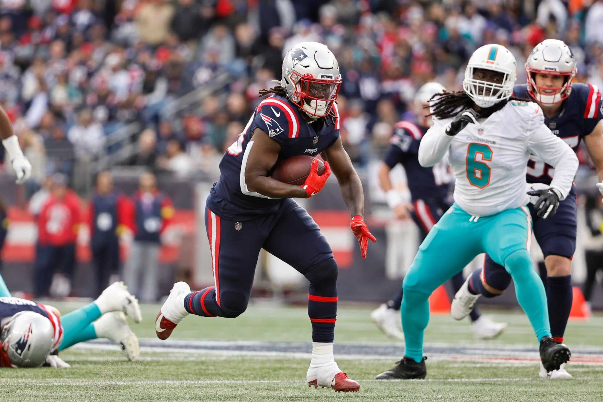 FOXBOROUGH, MASSACHUSETTS - JANUARY 01: Rhamondre Stevenson #38 of the New England Patriots runs against the Miami Dolphins during the game at Gillette Stadium on January 01, 2023 in Foxborough, Massachusetts. (Photo by Winslow Townson/Getty Images)