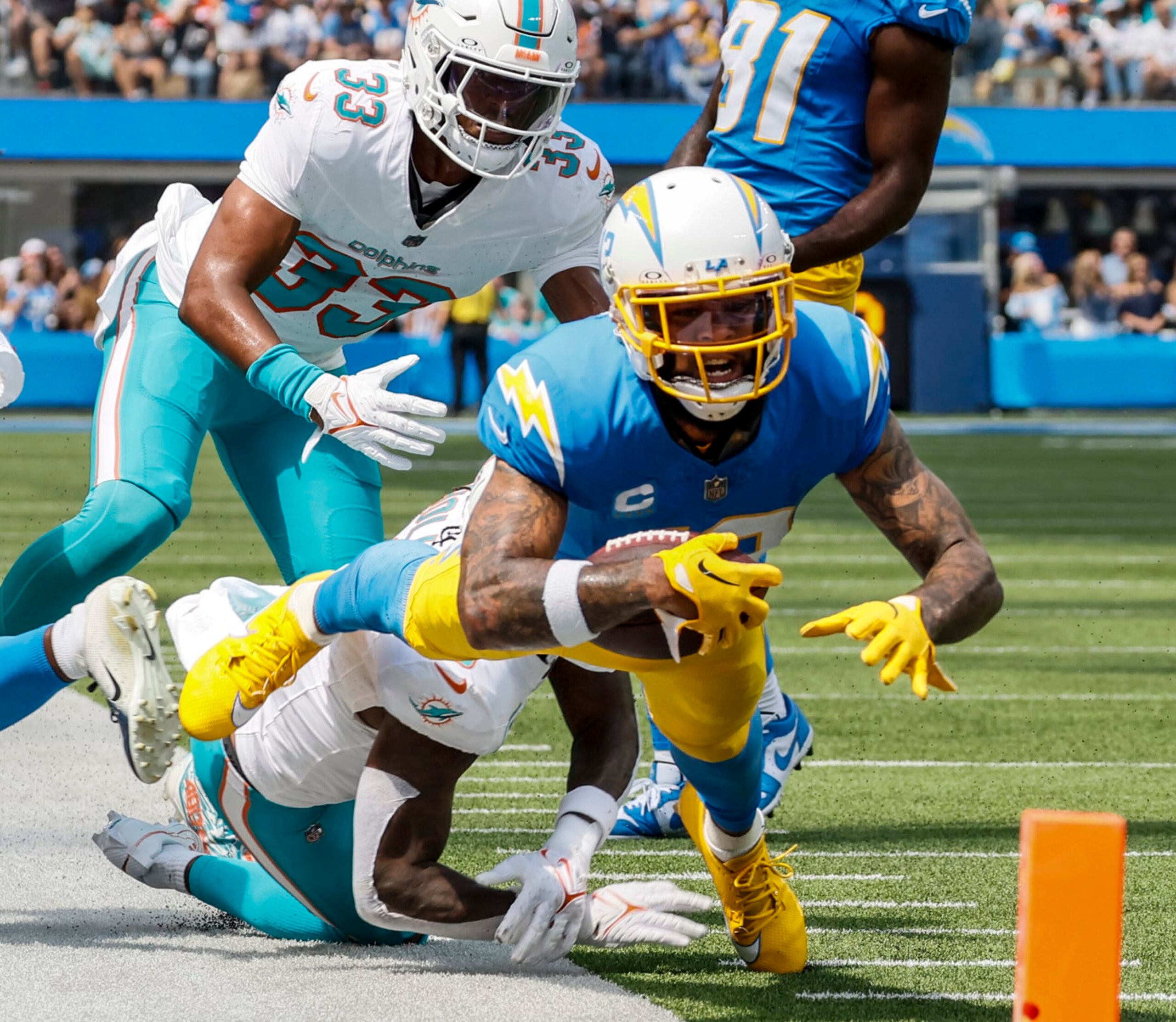 Inglewood, CA, Sunday, Sept. 10, 2023 - Los Angeles Chargers wide receiver Keenan Allen (13) strains to gain yardage on a play against the Miami Dolphins at SoFi Stadium.  (Robert Gauthier/Los Angeles Times via Getty Images)