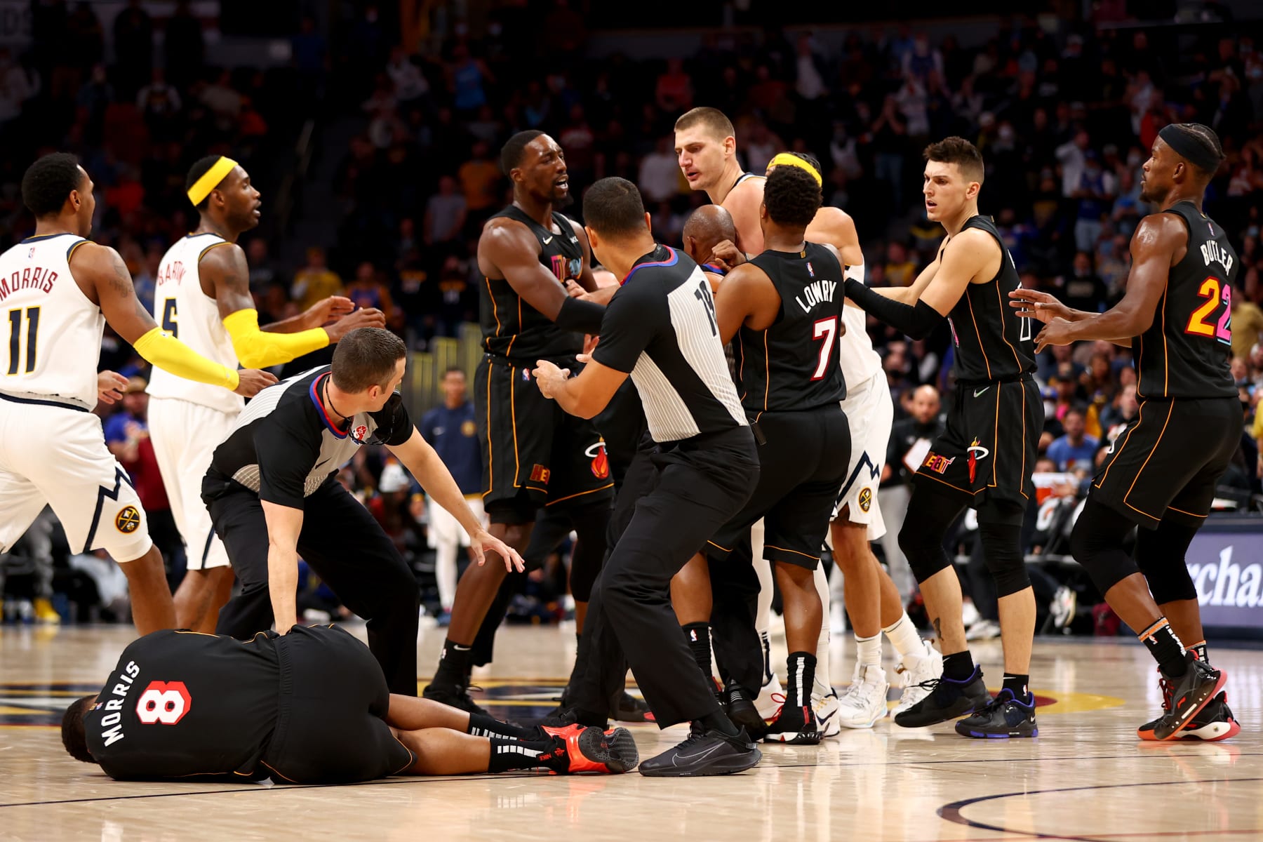DENVER, CO - NOVEMBER 08: Markieff Morris #8 of the Miami Heat lays on the ground after being hit by Nikola Jokic #15 of the Denver Nuggets at Ball Arena on November 8, 2021 in Denver, Colorado. NOTE TO USER: User expressly acknowledges and agrees that, by downloading and or using this photograph, User is consenting to the terms and conditions of the Getty Images License Agreement. (Photo by Jamie Schwaberow/Getty Images)