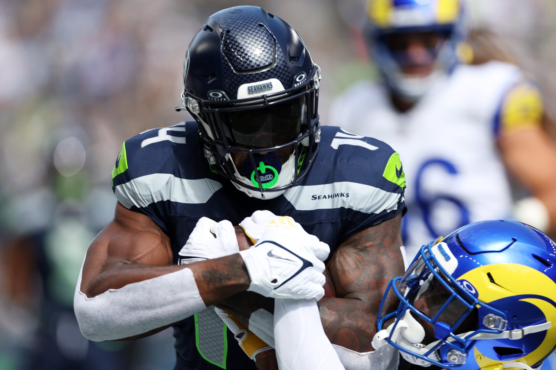 SEATTLE, WASHINGTON - SEPTEMBER 10:  DK Metcalf #14 of the Seattle Seahawks runs the ball against Jordan Fuller #4 of the Los Angeles Rams \d1h at Lumen Field on September 10, 2023 in Seattle, Washington. (Photo by Steph Chambers/Getty Images)