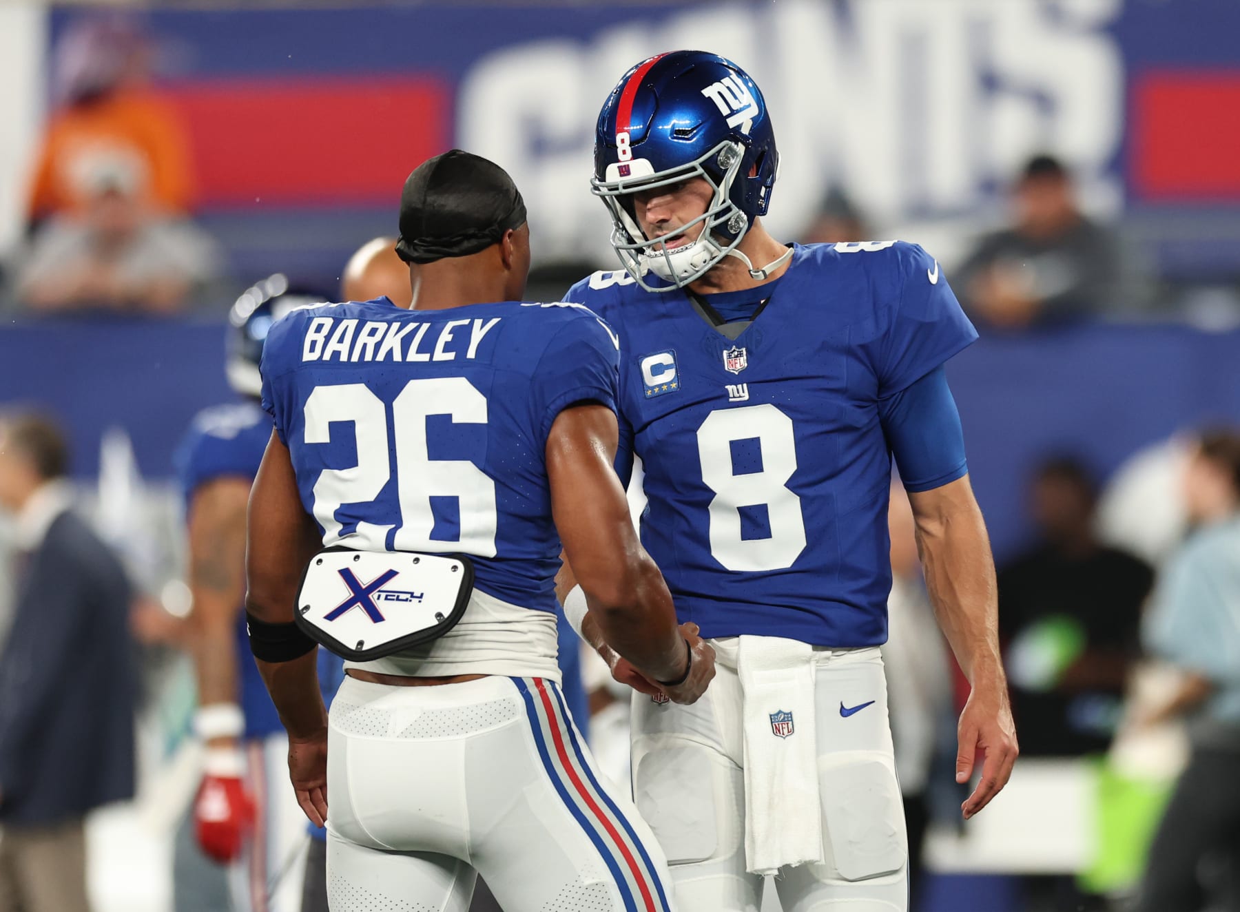 EAST RUTHERFORD, NEW JERSEY - SEPTEMBER 10: Daniel Jones #8 and Saquon Barkley #26 of the New York Giants talk during warmups prior to a game against the Dallas Cowboys at MetLife Stadium on September 10, 2023 in East Rutherford, New Jersey. (Photo by Tim Nwachukwu/Getty Images)