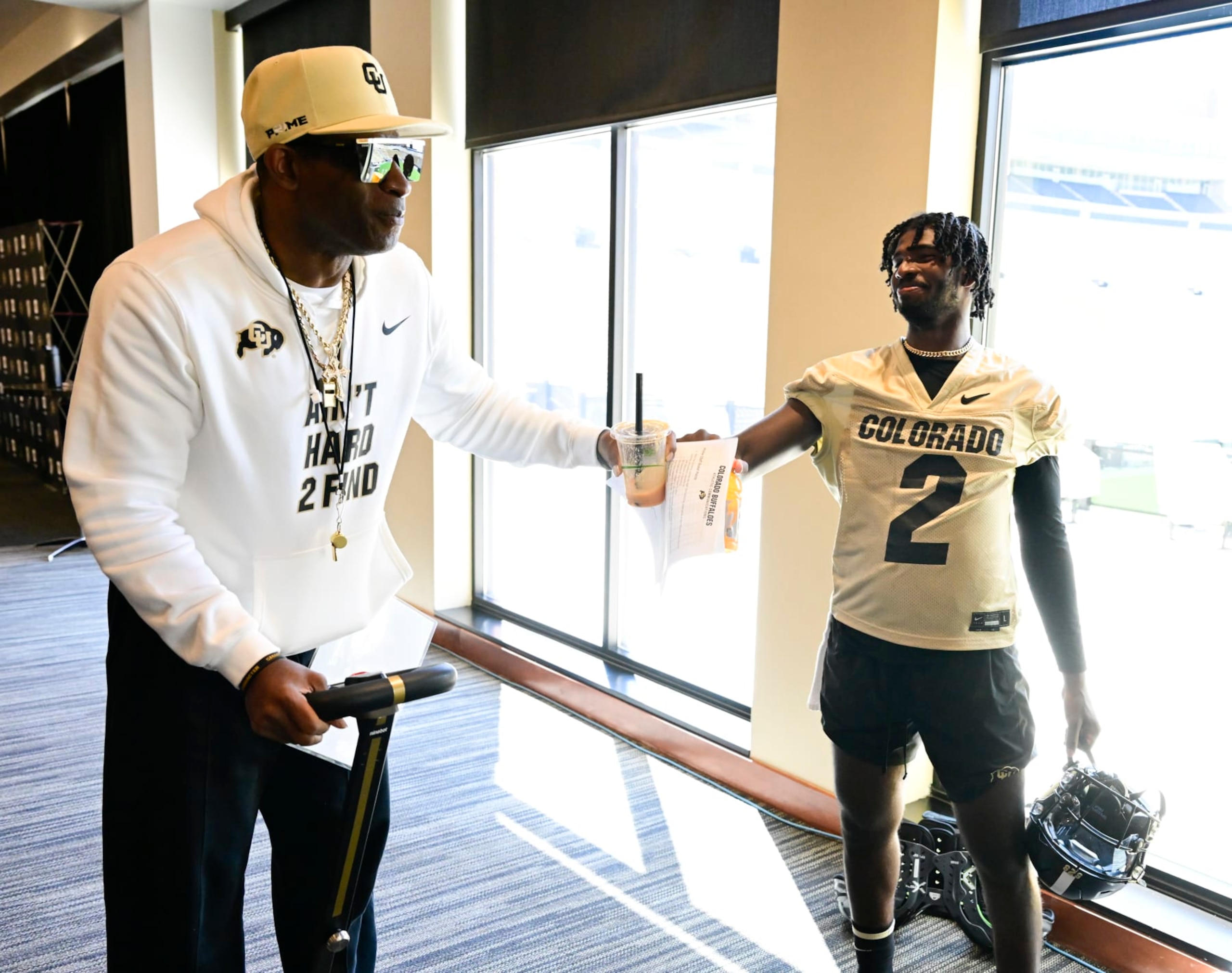 BOULDER, CO - AUGUST 11: Colorado Buffaloes head coach Deion Sanders fist bumps his son, quarterback Shedeur Sanders after taking questions at the 70th annual Colorado University Fall Sports Media Day after practice in Boulder August 11, 2023. (Photo by Andy Cross/MediaNews Group/The Denver Post via Getty Images)