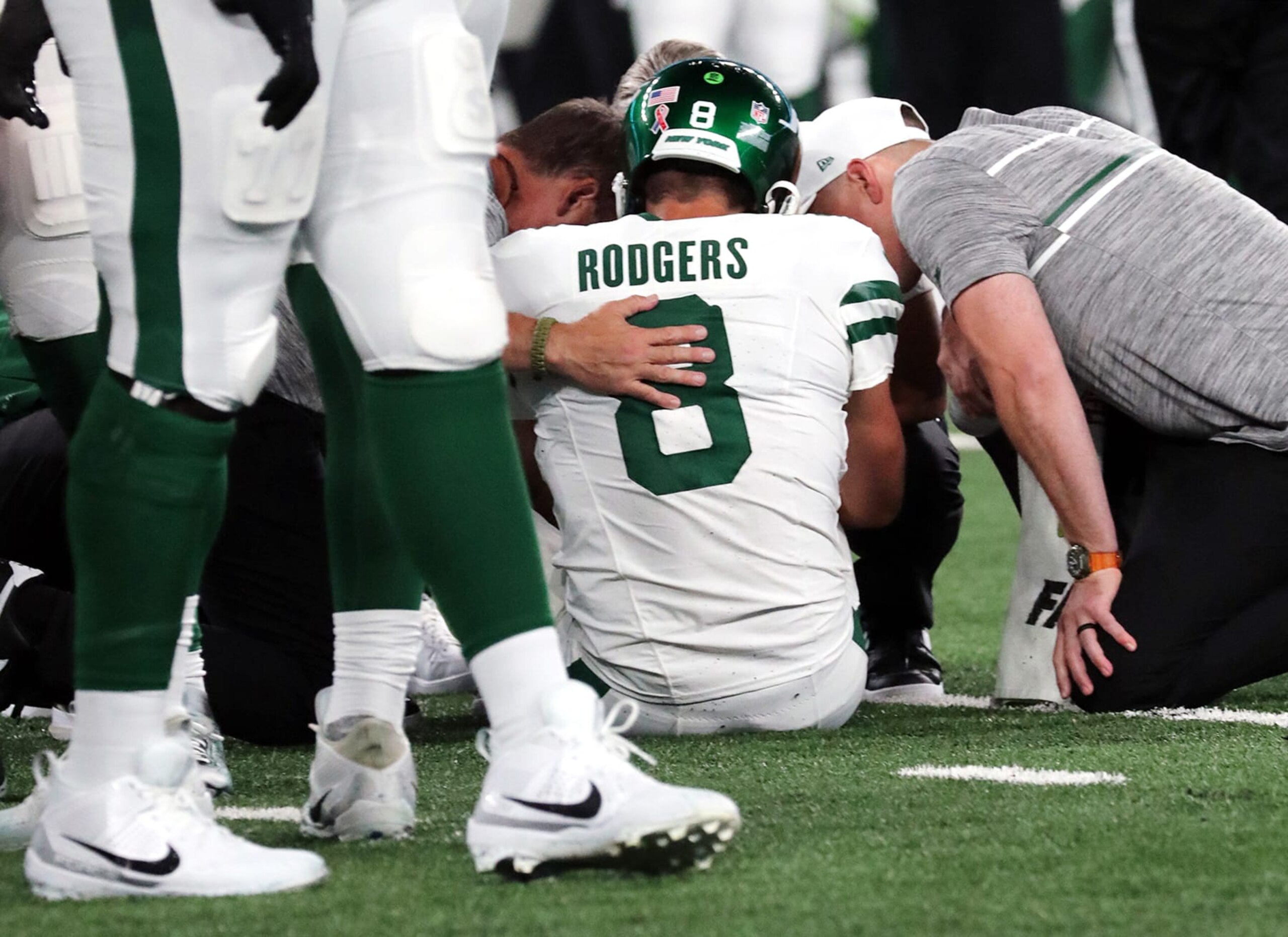 EAST RUTHERFORD, NEW JERSEY - SEPTEMBER 11: Quarterback Aaron Rodgers #8 of the New York Jets is attended to after being sacked by Leonard Floyd #56 of the Buffalo Bills and suffering an apparent Achilles injury in the game at MetLife Stadium on September 11, 2023 in East Rutherford, New Jersey.  (Photo by Al Pereira/Getty Images)