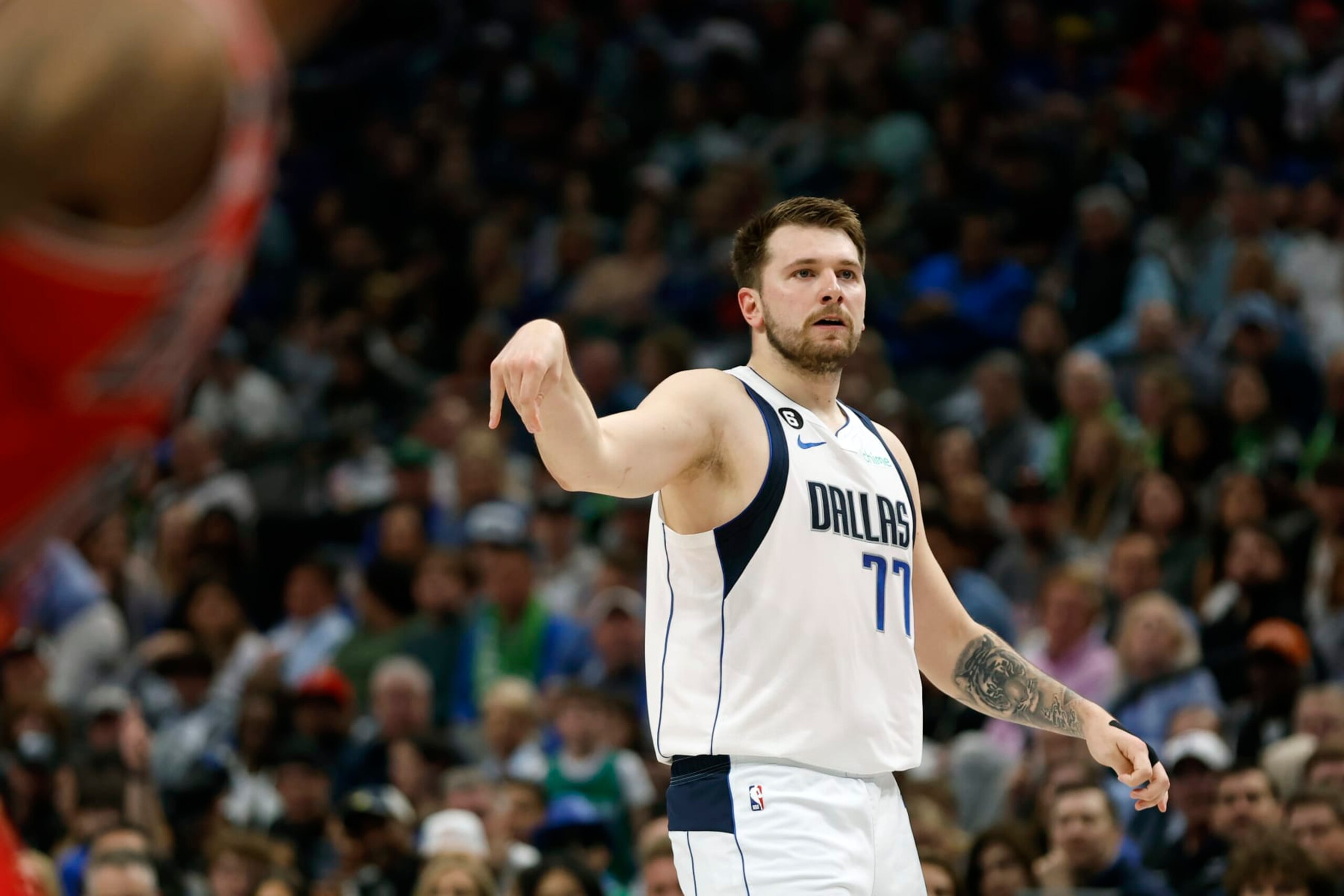 DALLAS, TEXAS - APRIL 07: Luka Doncic #77 of the Dallas Mavericks watches a shot in the first half against the Chicago Bulls at American Airlines Center on April 07, 2023 in Dallas, Texas. NOTE TO USER: User expressly acknowledges and agrees that, by downloading and or using this photograph, User is consenting to the terms and conditions of the Getty Images License Agreement. (Photo by Tim Heitman/Getty Images)