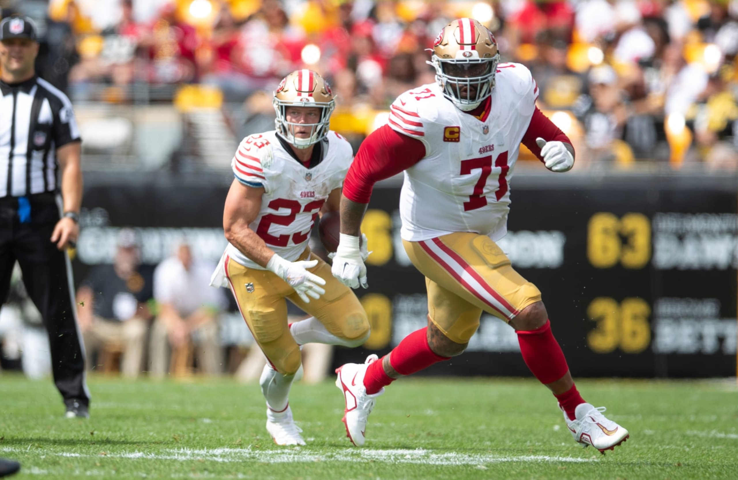 PITTSBURGH, PA - September 10: Christian McCaffrey #23  of the San Francisco 49ers rushes as Trent Williams #71 blocks during the game against the Pittsburgh Steelers at Acrisure Stadium on September 10, 2023 in Pittsburgh, Pennsylvania. The 49ers defeated the Steelers 30-7. (Photo by Michael Zagaris/San Francisco 49ers/Getty Images)