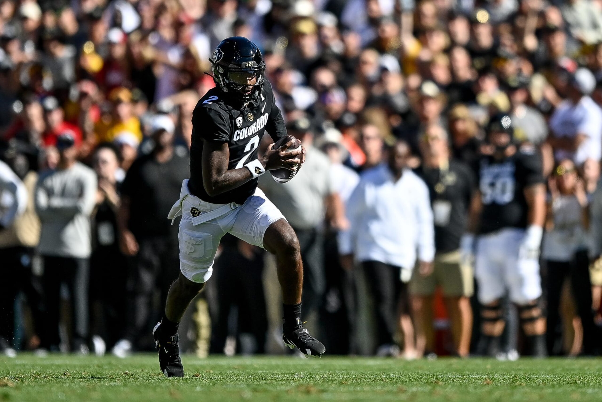 BOULDER, CO - SEPTEMBER 9:  Quarterback Shedeur Sanders #2 of the Colorado Buffaloes looks downfield as he runs in the first quarter against the Nebraska Cornhuskers at Folsom Field on September 9, 2023 in Boulder, Colorado. (Photo by Dustin Bradford/Getty Images)