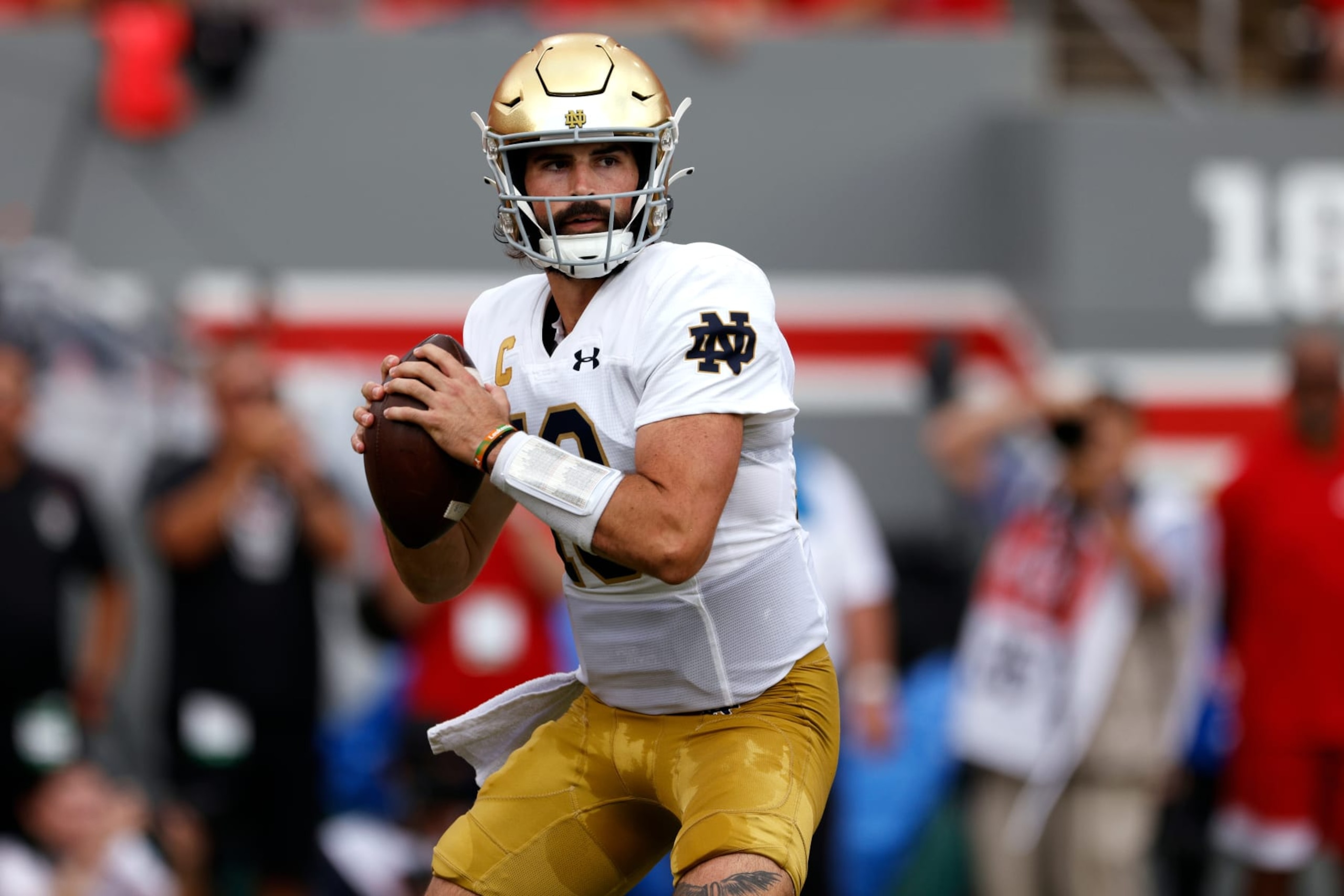 RALEIGH, NORTH CAROLINA - SEPTEMBER 9: Sam Hartman #10 of the Notre Dame Fighting Irish drops back to pass against the NC State Wolfpack at Carter-Finley Stadium on September 9, 2023 in Raleigh, North Carolina. Notre Dame won 45-24. (Photo by Lance King/Getty Images) RALEIGH, NORTH CAROLINA - SEPTEMBER 9: Sam Hartman #10 of the Notre Dame Fighting Irish drops back to pass against the NC State Wolfpack at Carter-Finley Stadium on September 9, 2023 in Raleigh, North Carolina. Notre Dame won 45-24. (Photo by Lance King/Getty Images)