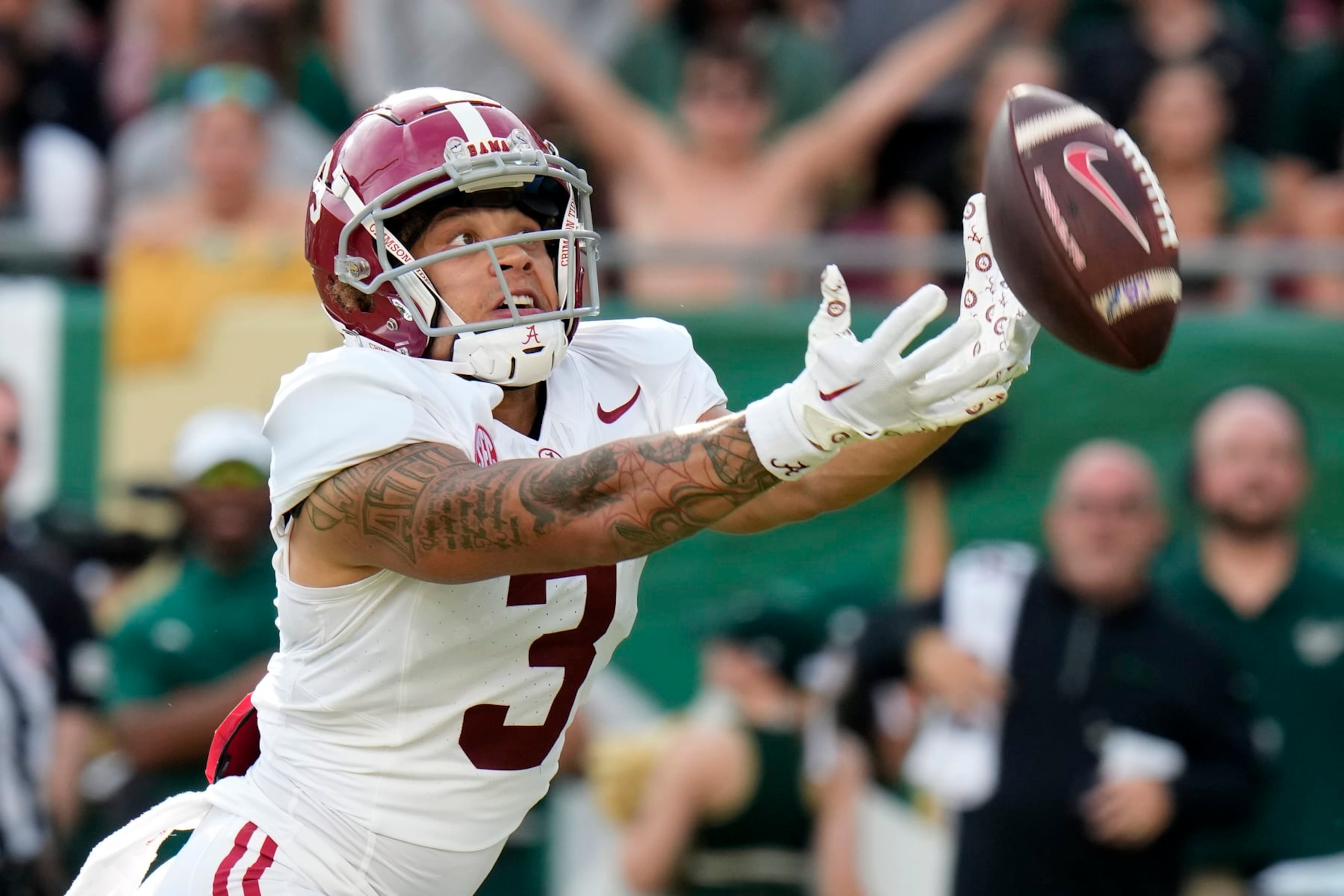 Alabama wide receiver Jermaine Burton can't catch a pass from quarterback Tyler Buchner during the first half of an NCAA college football game against South Florida Saturday, Sept. 16, 2023, in Tampa, Fla. (AP Photo/Chris O'Meara)