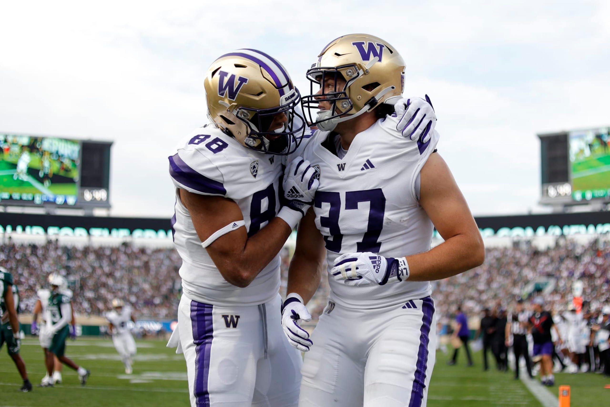 Washington's Jack Westover, right, and Quentin Moore celebrate Westover's touchdown against Michigan State during the first half of an NCAA college football game, Saturday, Sept. 16, 2023, in East Lansing, Mich. (AP Photo/Al Goldis)