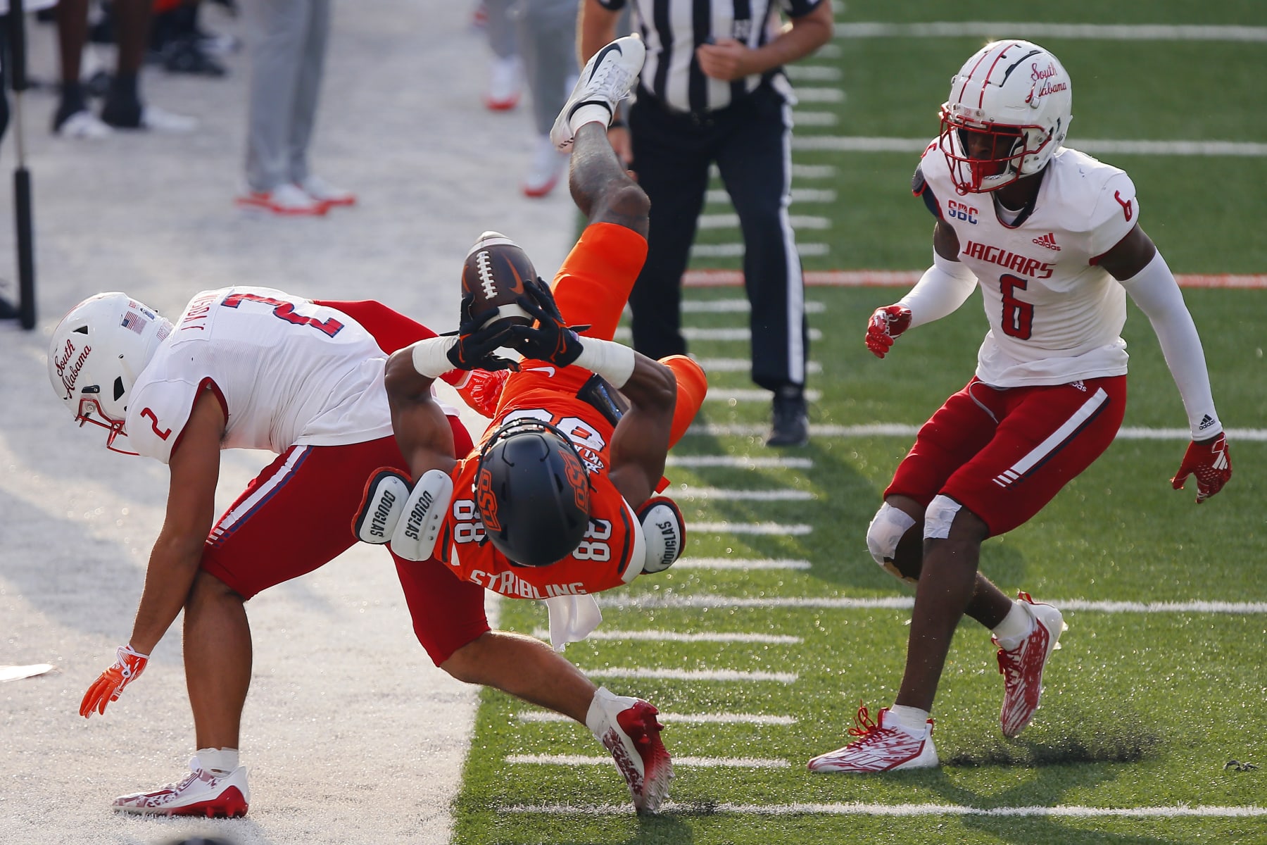 STILLWATER, OK - SEPTEMBER 16:  Wide receiver De'Zhaun Stribling #88 of the Oklahoma State Cowboys fails to land in bounds for a catch against safety Jaden Voisin #2 and cornerback Ricky Fletcher #6 of the South Alabama Jaguars in the first quarter at Boone Pickens Stadium on September 16, 2023 in Stillwater, Oklahoma.  (Photo by Brian Bahr/Getty Images)