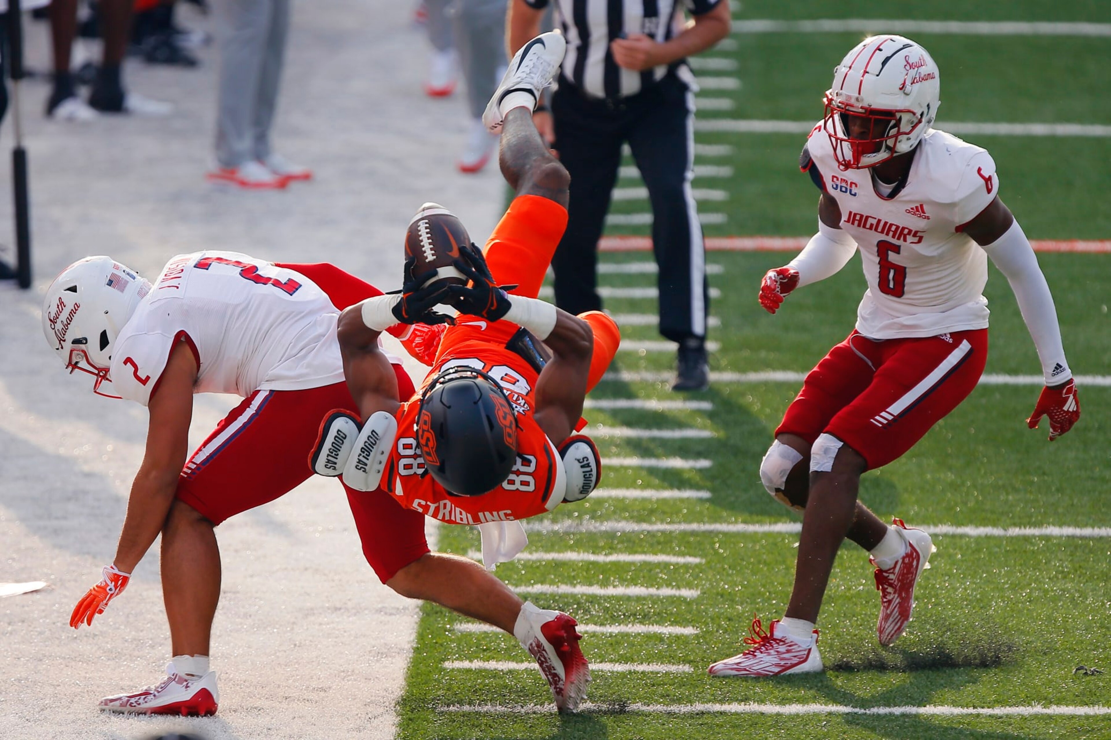 STILLWATER, OK - SEPTEMBER 16:  Wide receiver De'Zhaun Stribling #88 of the Oklahoma State Cowboys fails to land in bounds for a catch against safety Jaden Voisin #2 and cornerback Ricky Fletcher #6 of the South Alabama Jaguars in the first quarter at Boone Pickens Stadium on September 16, 2023 in Stillwater, Oklahoma.  (Photo by Brian Bahr/Getty Images)