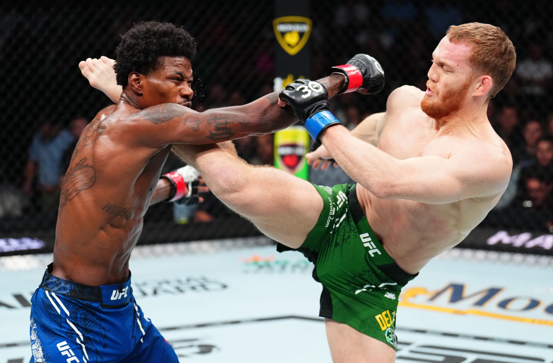 LAS VEGAS, NEVADA - SEPTEMBER 16: (R-L) Jack Della Maddalena of Australia kicks Kevin Holland in a welterweight fight during the Noche UFC event at T-Mobile Arena on September 16, 2023 in Las Vegas, Nevada. (Photo by Chris Unger/Zuffa LLC via Getty Images)