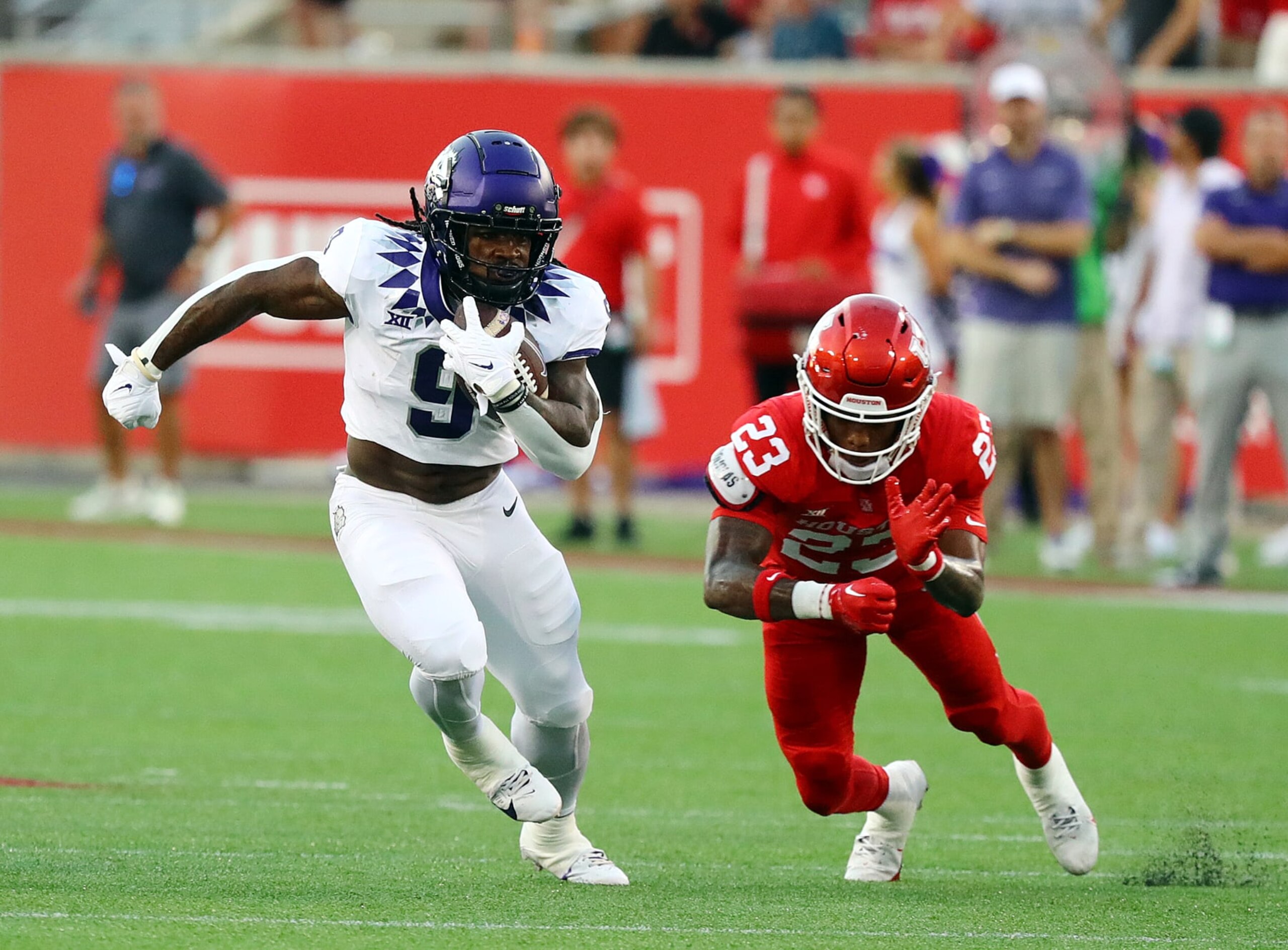 HOUSTON, TEXAS - SEPTEMBER 16: Emani Bailey #9 of the TCU Horned Frogs breaks a tackle attempt by Isaiah Hamilton #23 of the Houston Cougars during the first quarter at TDECU Stadium on September 16, 2023 in Houston, Texas. (Photo by Bob Levey/Getty Images) HOUSTON, TEXAS - SEPTEMBER 16: Emani Bailey #9 of the TCU Horned Frogs breaks a tackle attempt by Isaiah Hamilton #23 of the Houston Cougars during the first quarter at TDECU Stadium on September 16, 2023 in Houston, Texas. (Photo by Bob Levey/Getty Images)