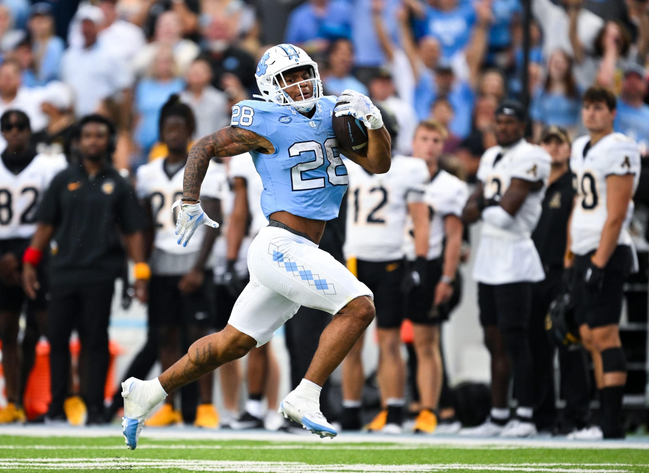 CHAPEL HILL, NORTH CAROLINA - SEPTEMBER 09: Omarion Hampton #28 of the North Carolina Tar Heels breaks free for a touchdown run against the Appalachian State Mountaineers during the first half of the game at Kenan Memorial Stadium on September 09, 2023 in Chapel Hill, North Carolina. (Photo by Grant Halverson/Getty Images) CHAPEL HILL, NORTH CAROLINA - SEPTEMBER 09: Omarion Hampton #28 of the North Carolina Tar Heels breaks free for a touchdown run against the Appalachian State Mountaineers during the first half of the game at Kenan Memorial Stadium on September 09, 2023 in Chapel Hill, North Carolina. (Photo by Grant Halverson/Getty Images)