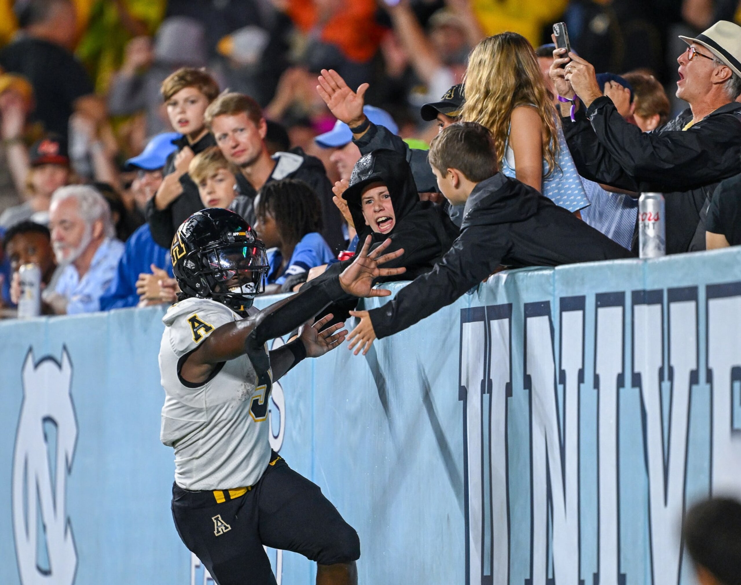 CHAPEL HILL, NORTH CAROLINA - SEPTEMBER 09: Nate Noel #5 of the Appalachian State Mountaineers c elebrates with fans after scoring a touchdown against the North Carolina Tar Heels during the game at Kenan Memorial Stadium on September 09, 2023 in Chapel Hill, North Carolina. The Tar Heels won 40-34 in double overtime. (Photo by Grant Halverson/Getty Images) CHAPEL HILL, NORTH CAROLINA - SEPTEMBER 09: Nate Noel #5 of the Appalachian State Mountaineers c elebrates with fans after scoring a touchdown against the North Carolina Tar Heels during the game at Kenan Memorial Stadium on September 09, 2023 in Chapel Hill, North Carolina. The Tar Heels won 40-34 in double overtime. (Photo by Grant Halverson/Getty Images)