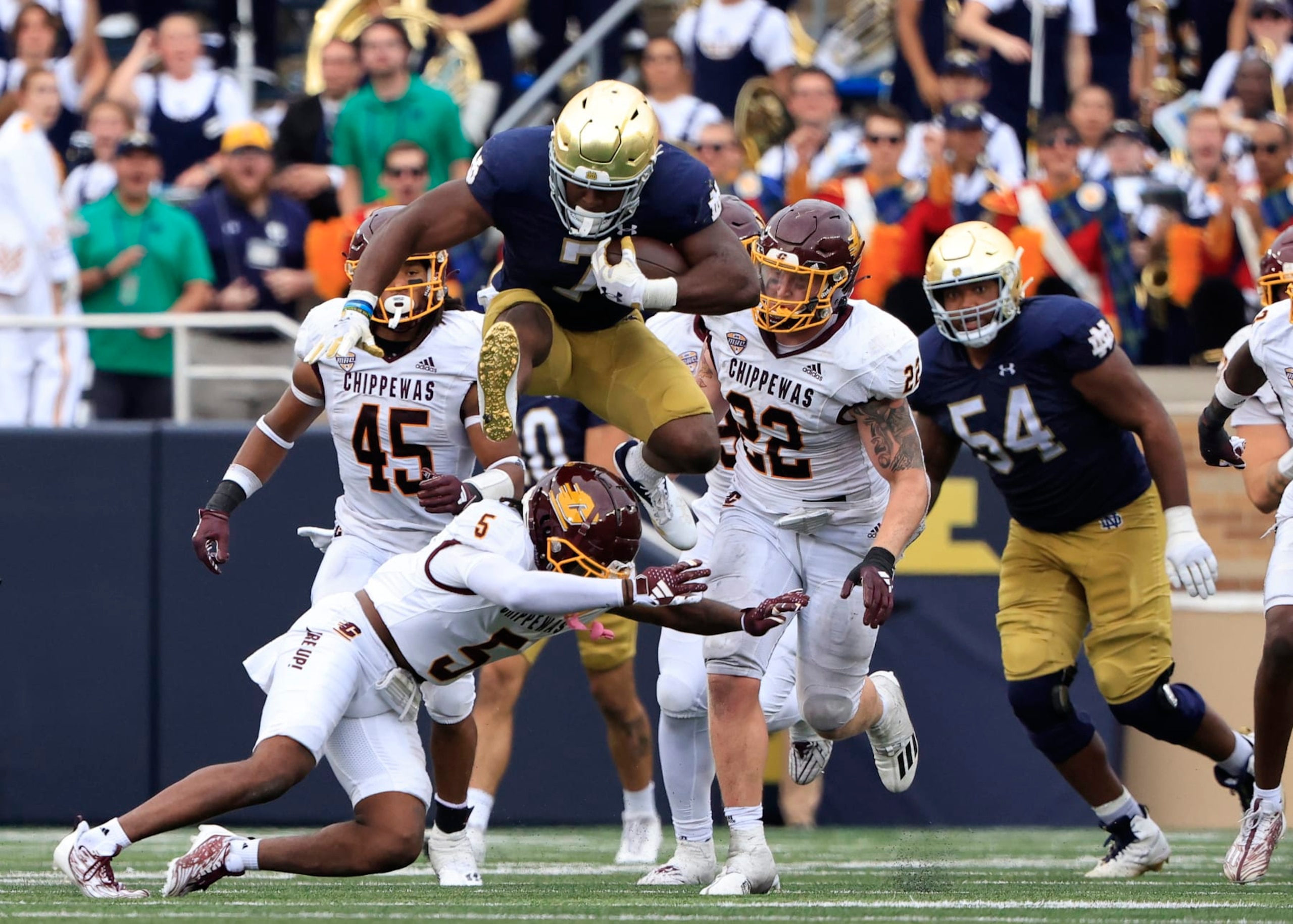 SOUTH BEND, INDIANA - SEPTEMBER 16: Audric Estime #7 of the Notre Dame Fighting Irish huddles over De'Javion Stepney #5 of the Central Michigan Chippewas during the second half at Notre Dame Stadium on September 16, 2023 in South Bend, Indiana. (Photo by Justin Casterline/Getty Images) SOUTH BEND, INDIANA - SEPTEMBER 16: Audric Estime #7 of the Notre Dame Fighting Irish huddles over De'Javion Stepney #5 of the Central Michigan Chippewas during the second half at Notre Dame Stadium on September 16, 2023 in South Bend, Indiana. (Photo by Justin Casterline/Getty Images)