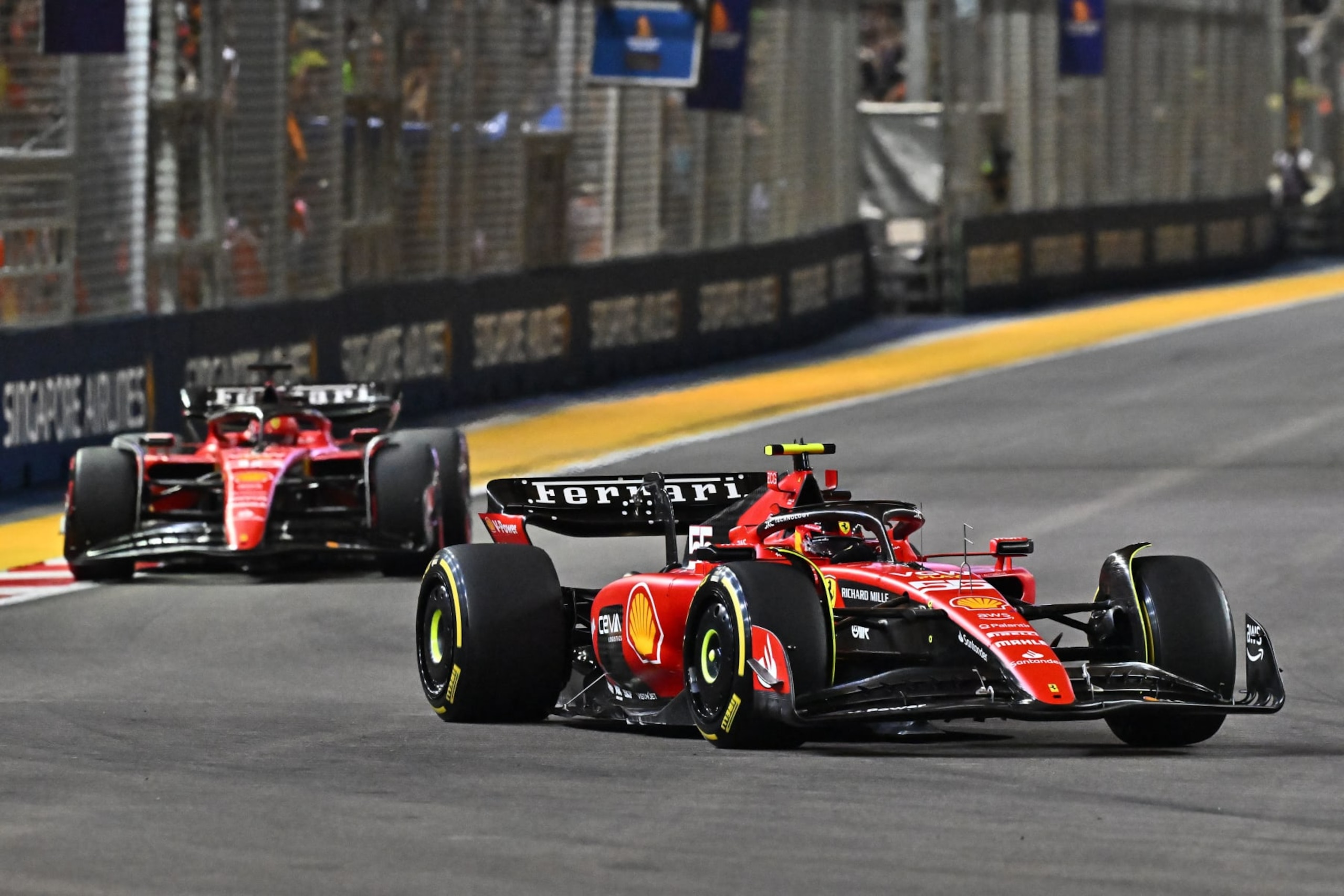 Ferrari's Spanish driver Carlos Sainz Jr (R) drives during the Singapore Formula One Grand Prix night race at the Marina Bay Street Circuit in Singapore on September 17, 2023. (Photo by Lillian SUWANRUMPHA / AFP) (Photo by LILLIAN SUWANRUMPHA/AFP via Getty Images)