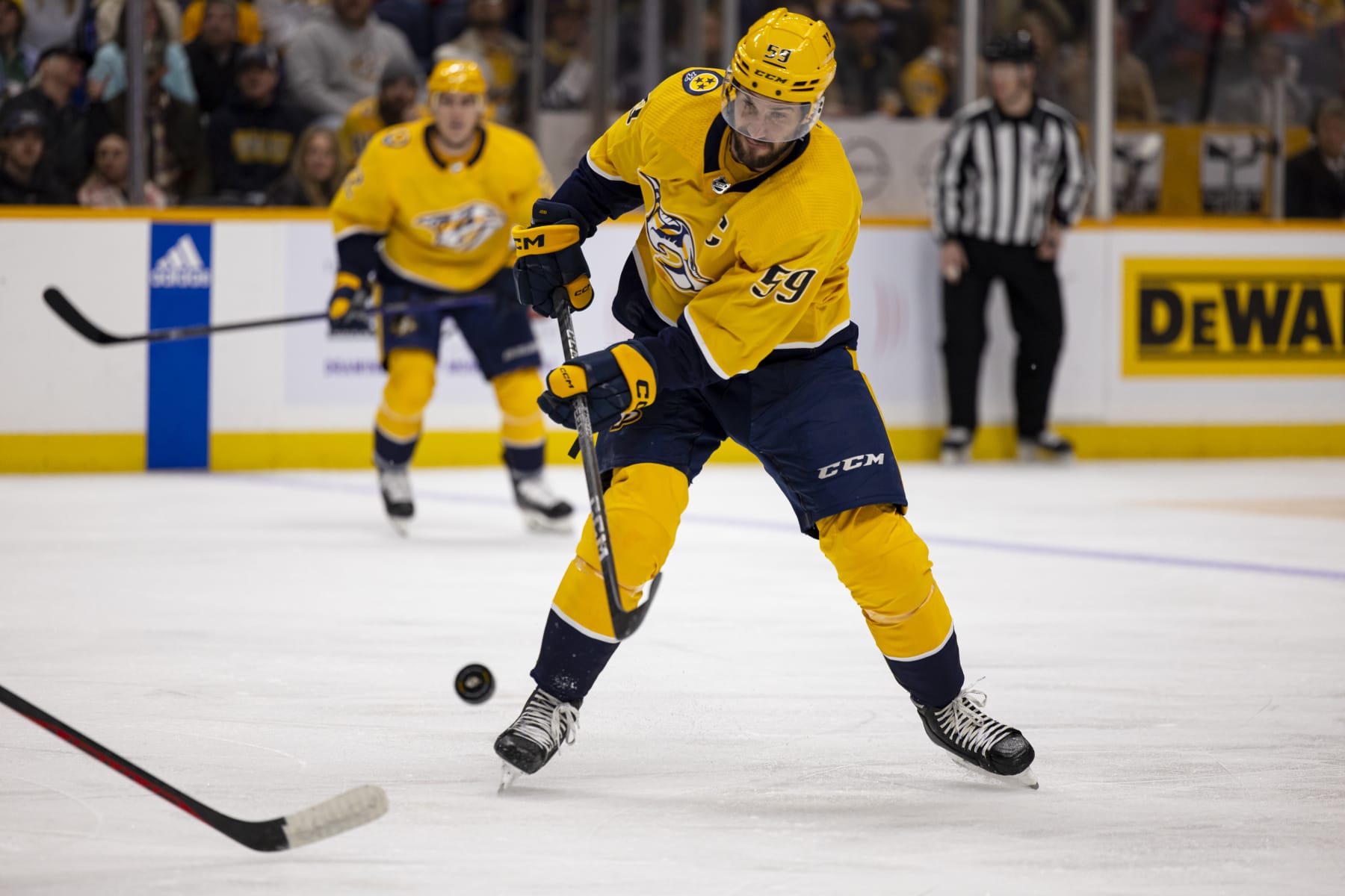NASHVILLE, TN - MARCH 14:  Roman Josi #59 of the Nashville Predators passes the puck during the first period against the Detroit Red Wings at Bridgestone Arena on March 14, 2023 in Nashville, Tennessee. (Photo by Brett Carlsen/Getty Images)