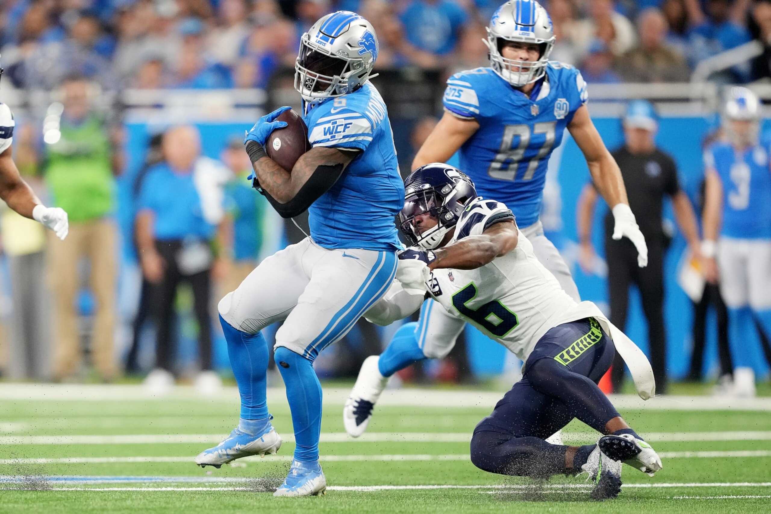 DETROIT, MICHIGAN - SEPTEMBER 17: David Montgomery #5 of the Detroit Lions is tackled by Quandre Diggs #6 of the Seattle Seahawks during the second quarter at Ford Field on September 17, 2023 in Detroit, Michigan. (Photo by Nic Antaya/Getty Images)