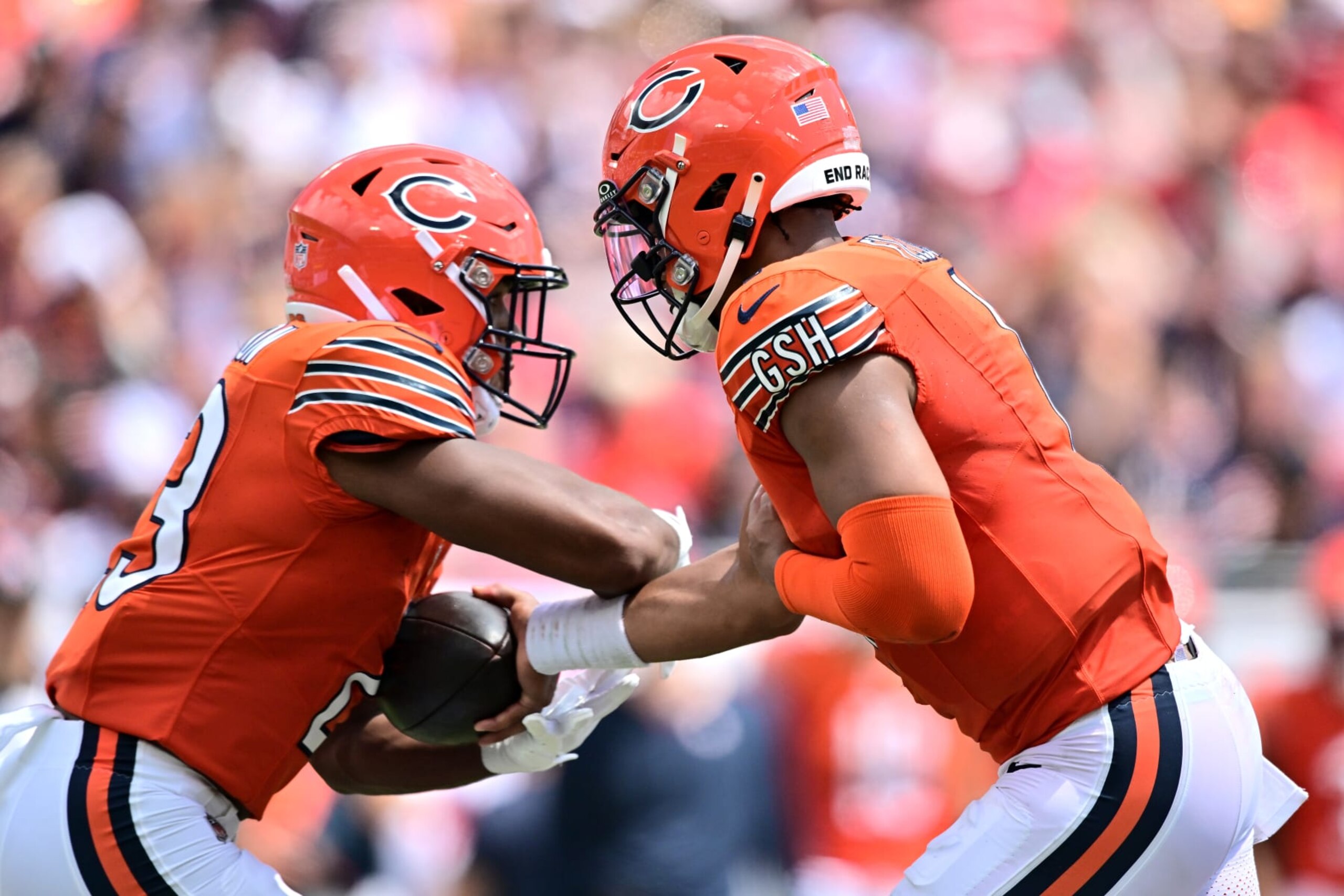 Justin Fields hands off to Roschon Johnson