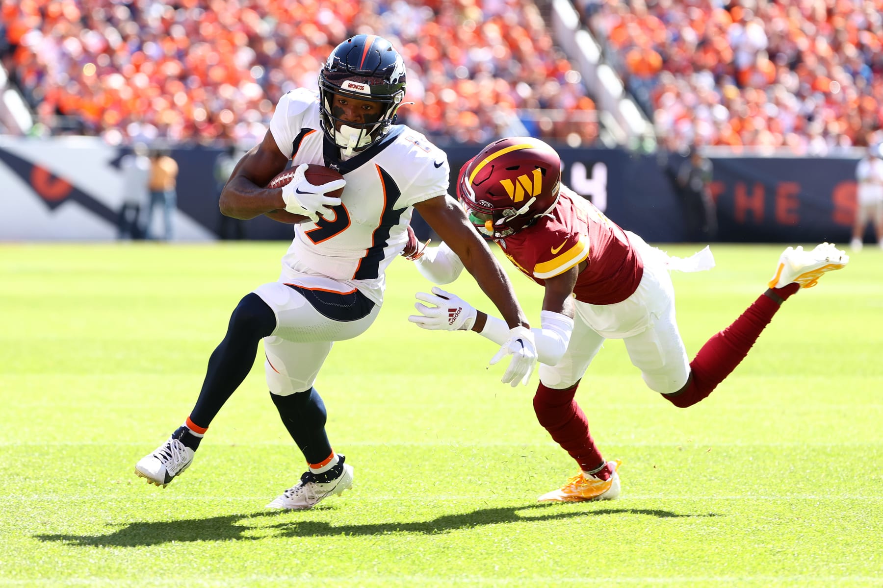 DENVER, COLORADO - SEPTEMBER 17: Marvin Mims Jr. #19 of the Denver Broncos runs past Kendall Fuller #29 of the Washington Commanders during the first quarter at Empower Field At Mile High on September 17, 2023 in Denver, Colorado. (Photo by Jamie Schwaberow/Getty Images)